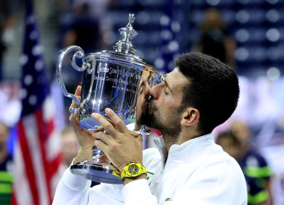 Serbia's Novak Djokovic celebrates with the trophy after winning the U.S. Open at Flushing Meadows, New York.