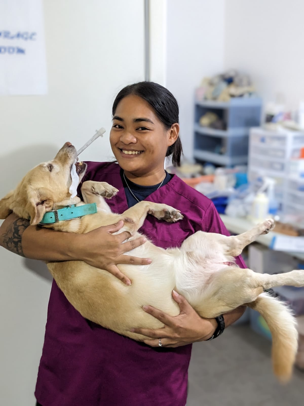 Dog Control Program staff member Stephanie Jo Camacho poses with a furry client.