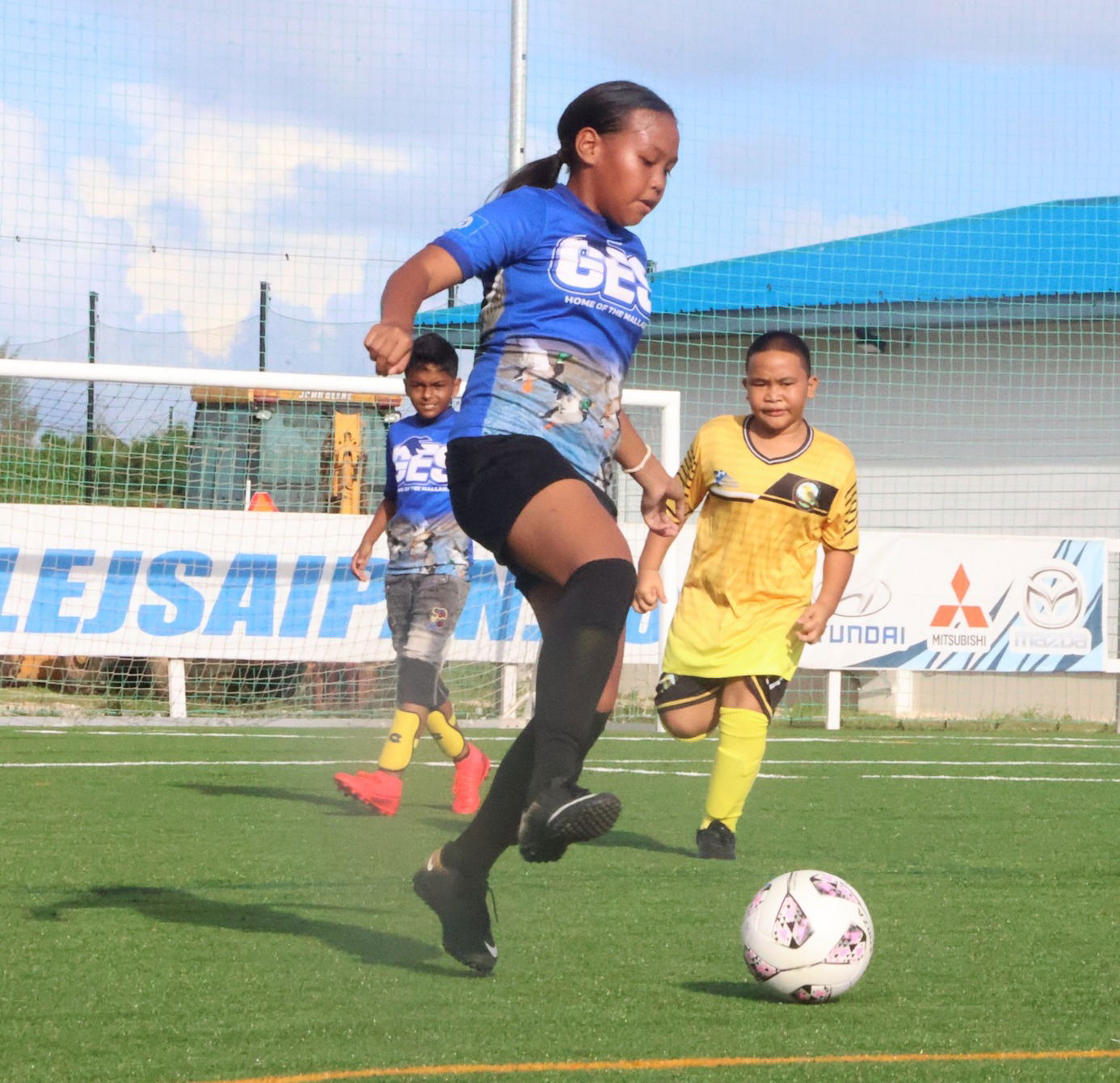 Garapan Elementary School 2's Althea Debelen reaches to control the possession against San Vicente Elementary School 2 during an elementary school division game of the NMIFA Interscholastic Soccer League SY23-24 on Monday at the NMI Soccer Training Center in Koblerville.