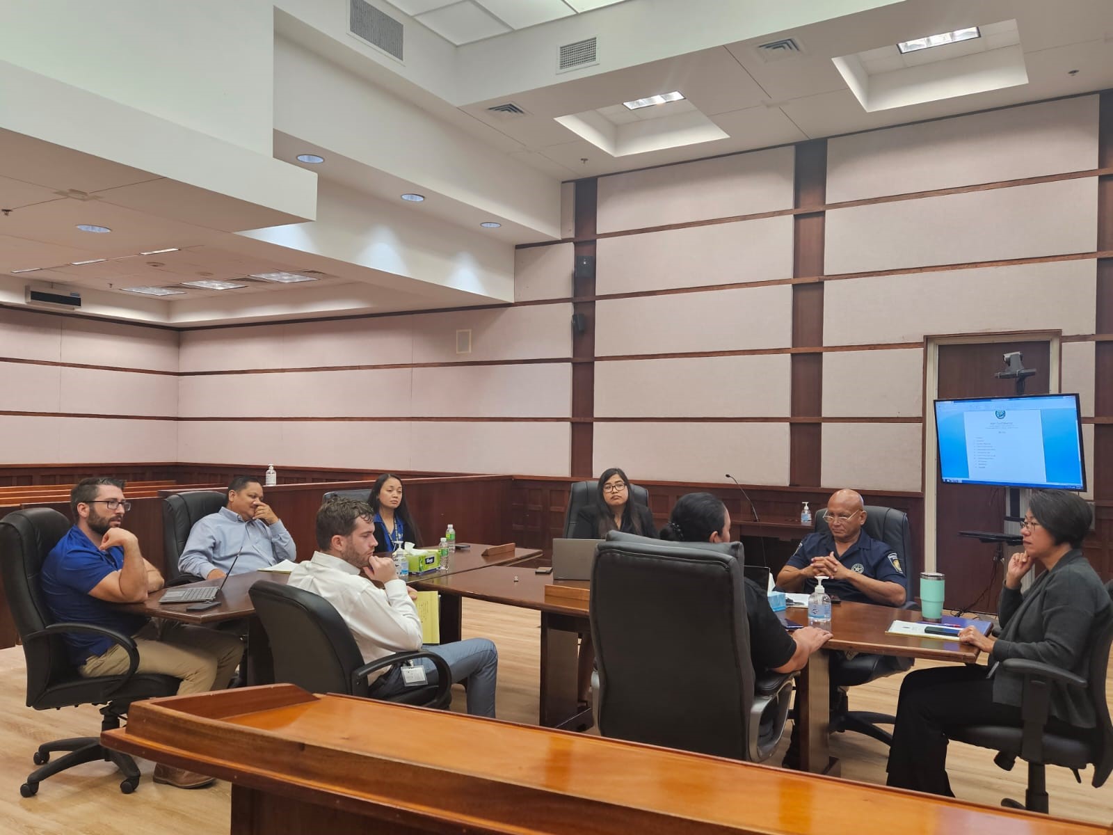 Associate Judge Teresa K. Kim-Tenorio, right, meets with judiciary managers to plan for the launch of the Family Court Division's night sessions on Aug. 17, 2023.