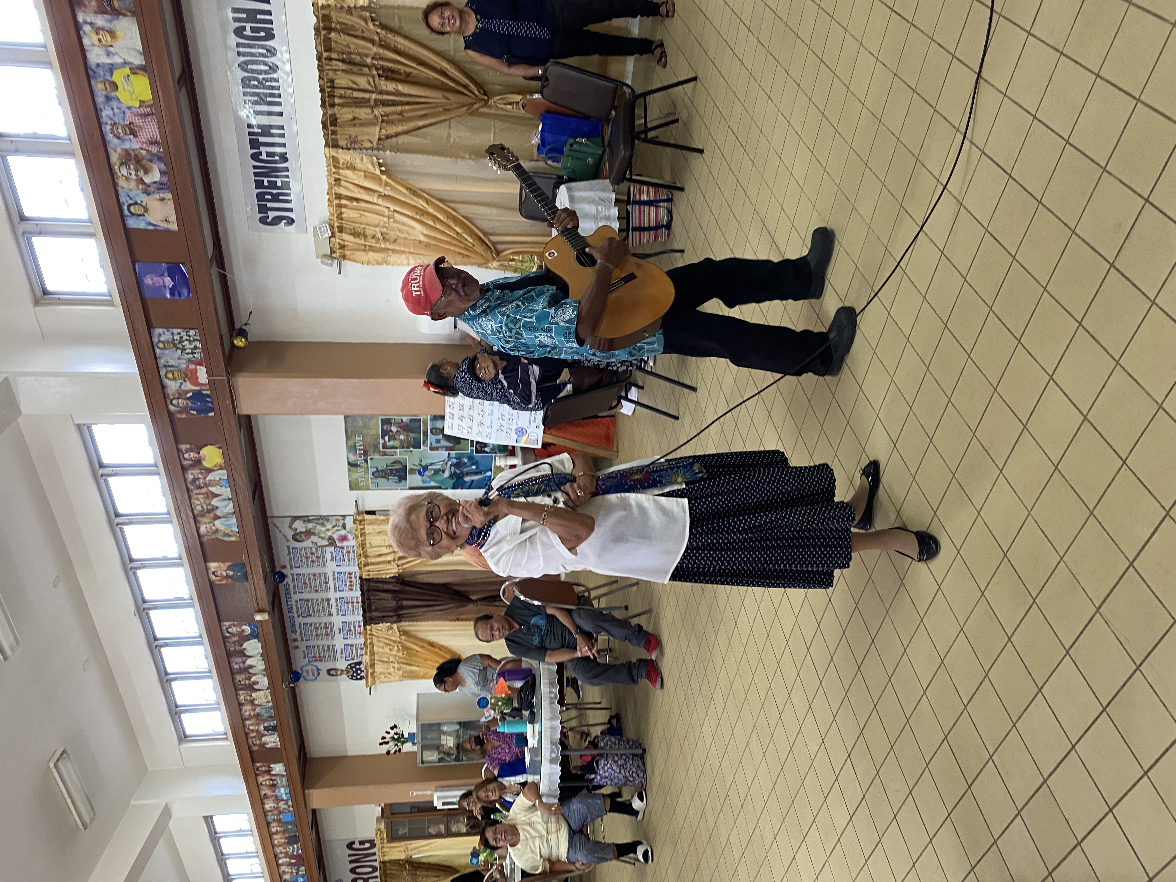 While waiting for lunch to begin, some of the senior citizens sang karaoke.