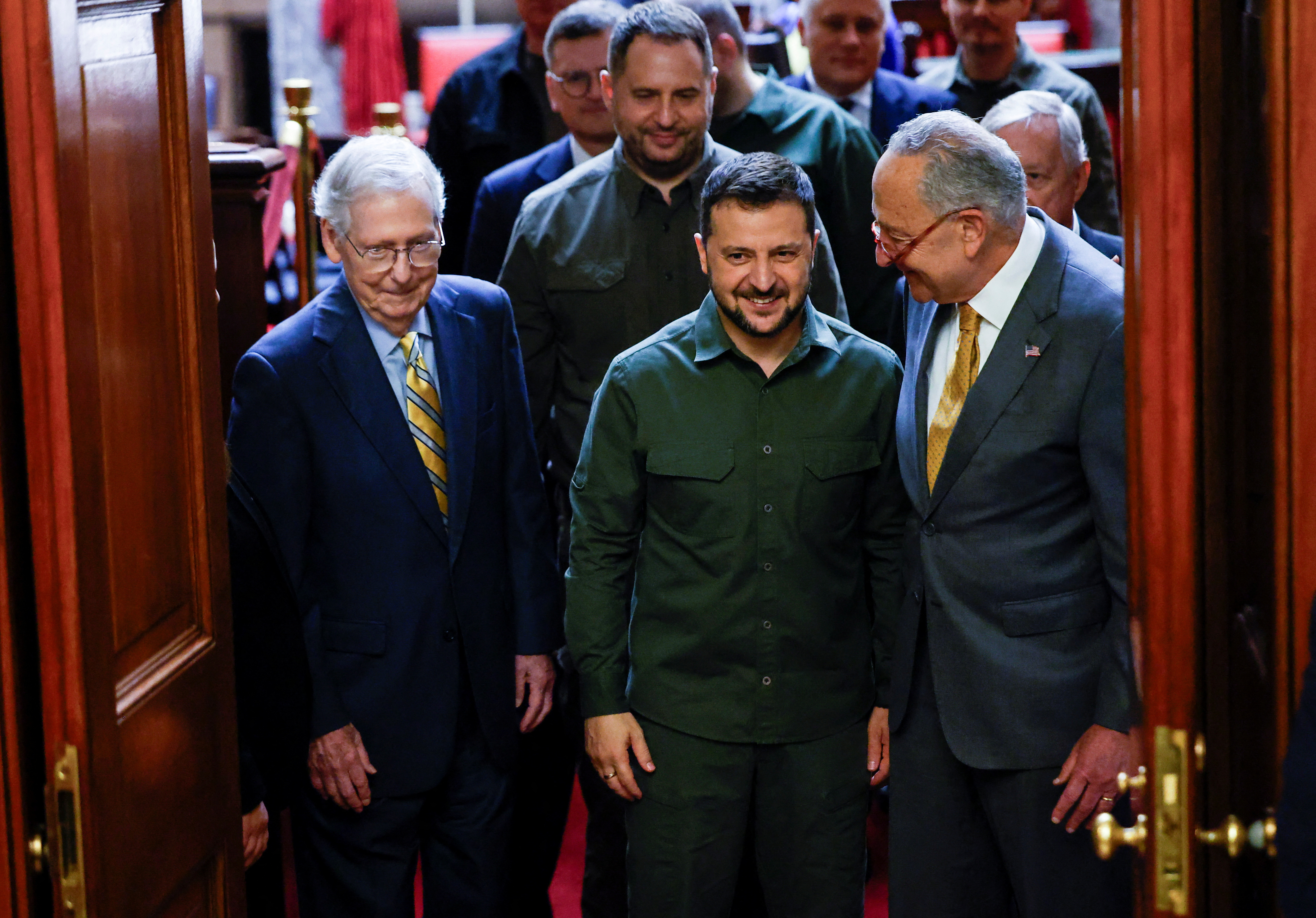 Ukrainian President Volodymyr Zelenskiy is escorted by U.S. Senate Minority Leader Mitch McConnell (R-KY) and Senate Majority Leader Chuck Schumer (D-NY) as he departs after a meeting with all members of the Senate on a visit to the U.S. Capitol in Washington, September 21, 2023. 