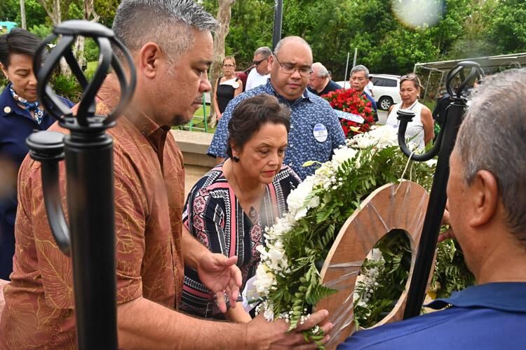 Sen. Chris Barnett, Gov. Lou Leon Guerrero and Mayor Jesse Alig hang a wreath representing Peace at the Peace Ceremony & Tribute in remembrance of Sept. 11 Monday Sept. 11, 2023 in Harmon. 