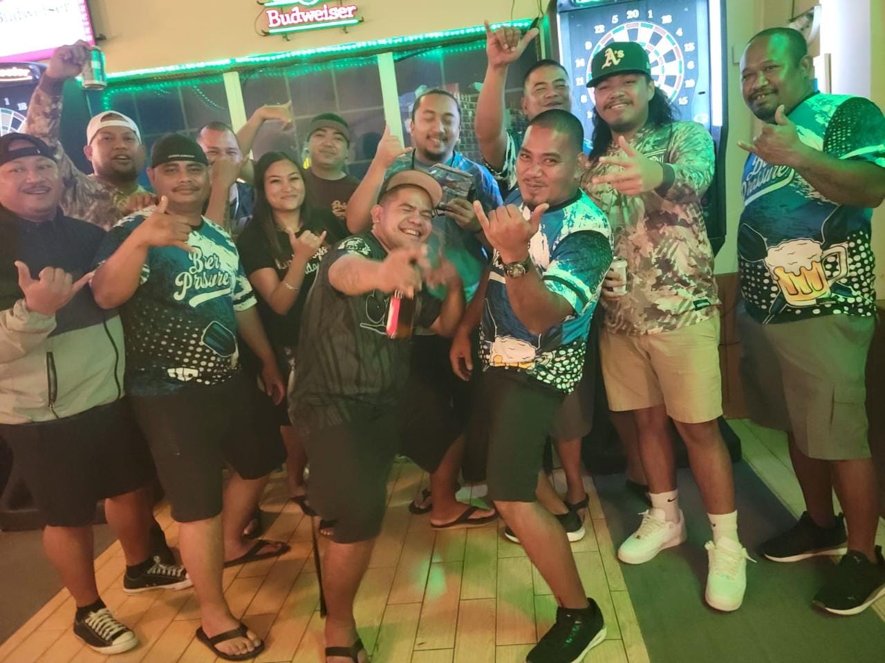 The players of Bistro Marianas Beer Pressure and 6JMS Seikid B pose for a photo after their game  Thursday in the Flame Tree B Division of the 2023 SEDA Bud Light Dart League at Bistro Marianas.