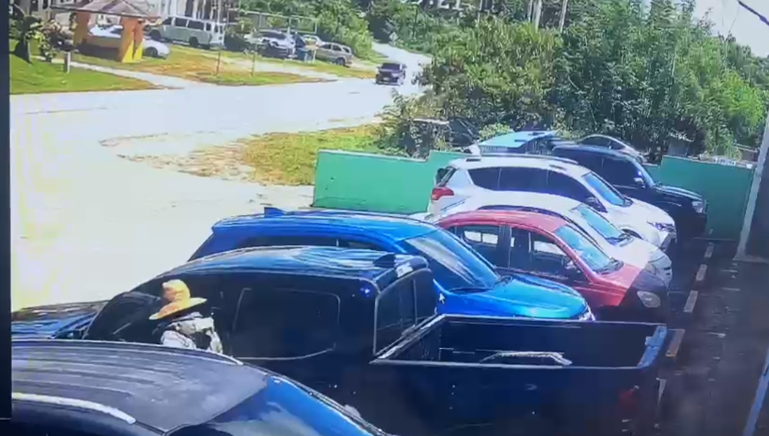 A man wearing a hat gets into a Toyota Tacoma parked outside Green Consume Market in As Lito at around 11 a.m. Tuesday.