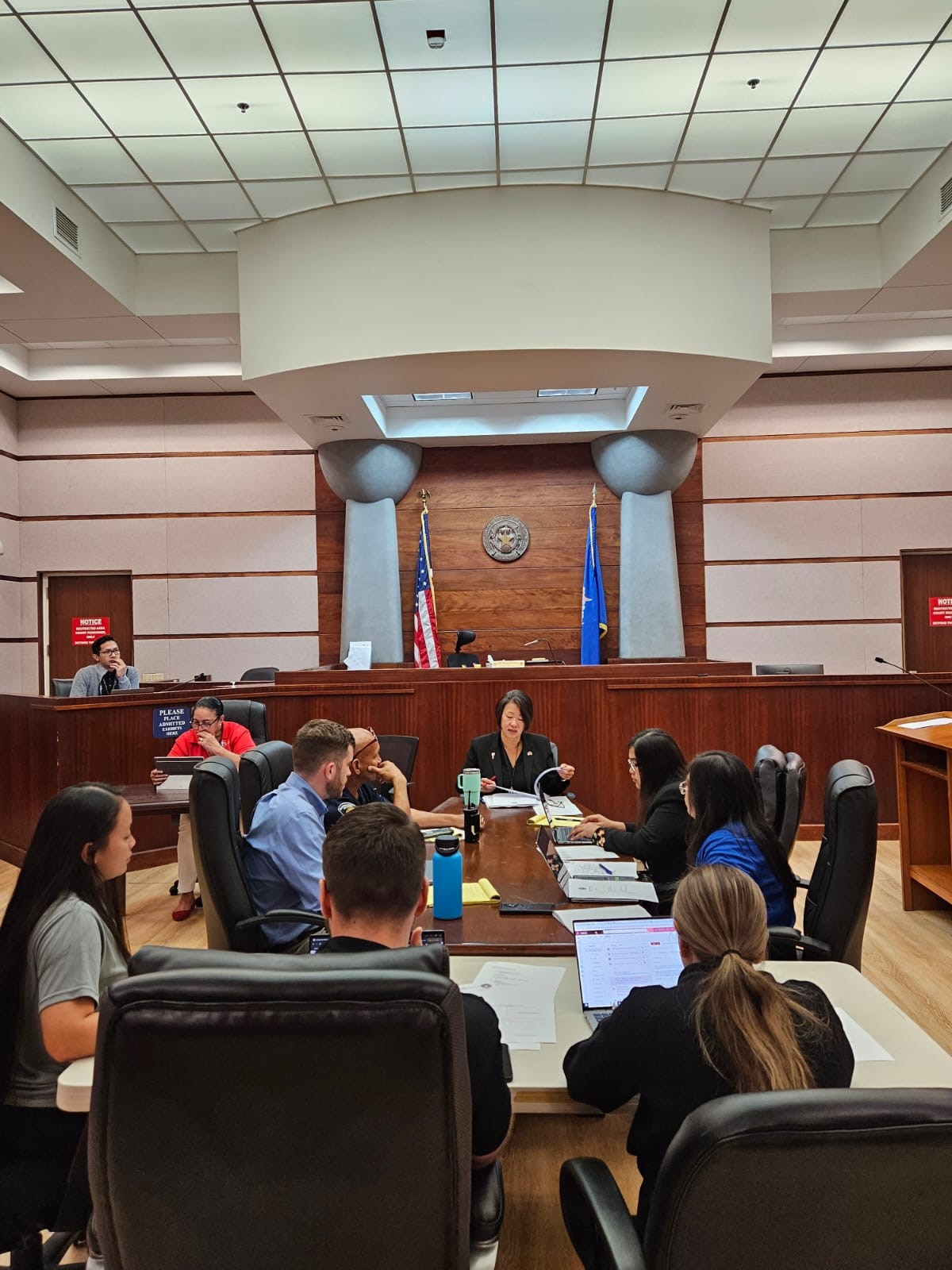 Associate Judge Teresa K. Kim-Tenorio, center background, meets with judiciary managers to plan for the Family Court Division's launch of night sessions on Sept. 7, 2023.