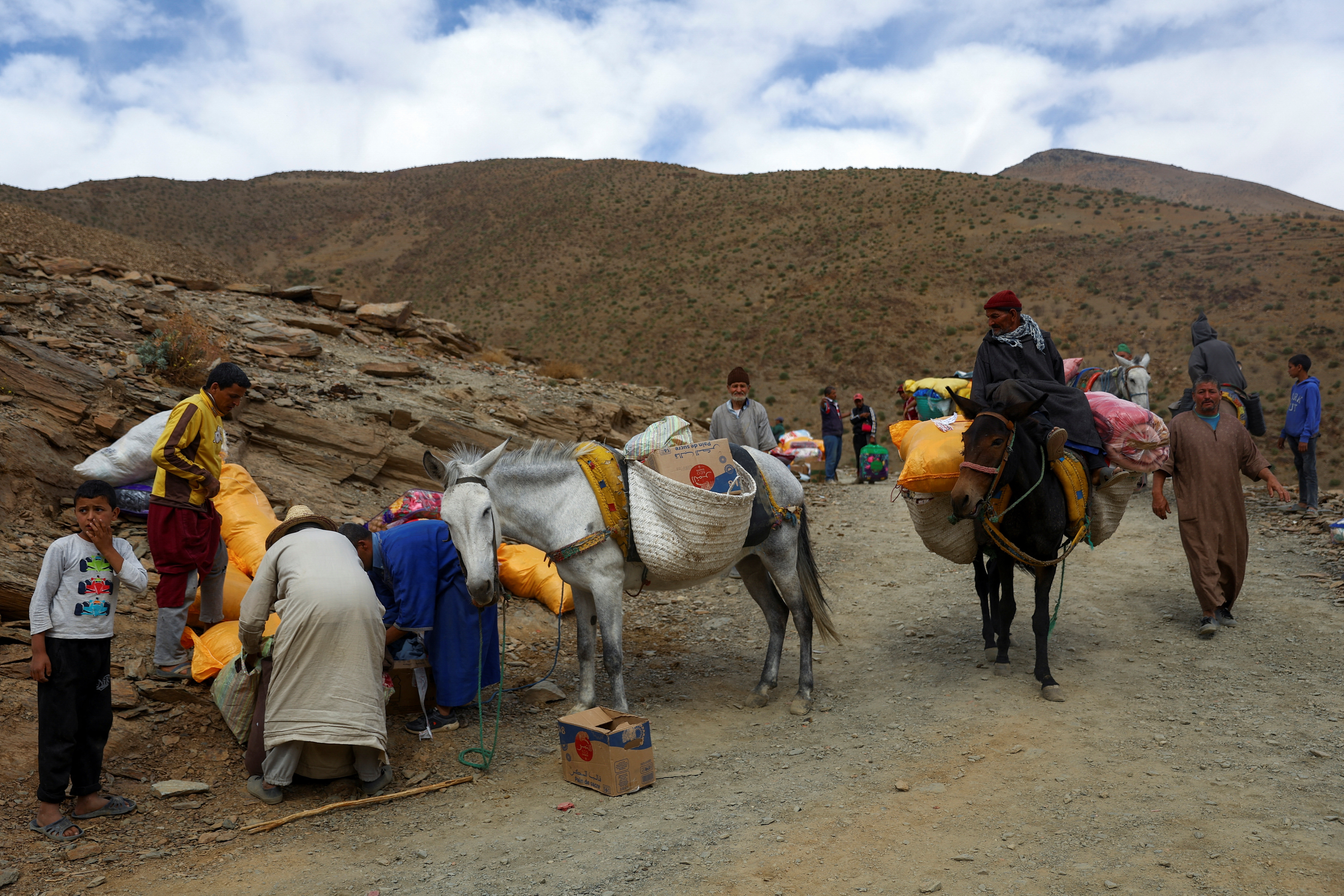 People load aid on animals to be distributed across the village in the aftermath of a deadly earthquake, in the rural village of Azermoun, Morocco September 14, 2023. 