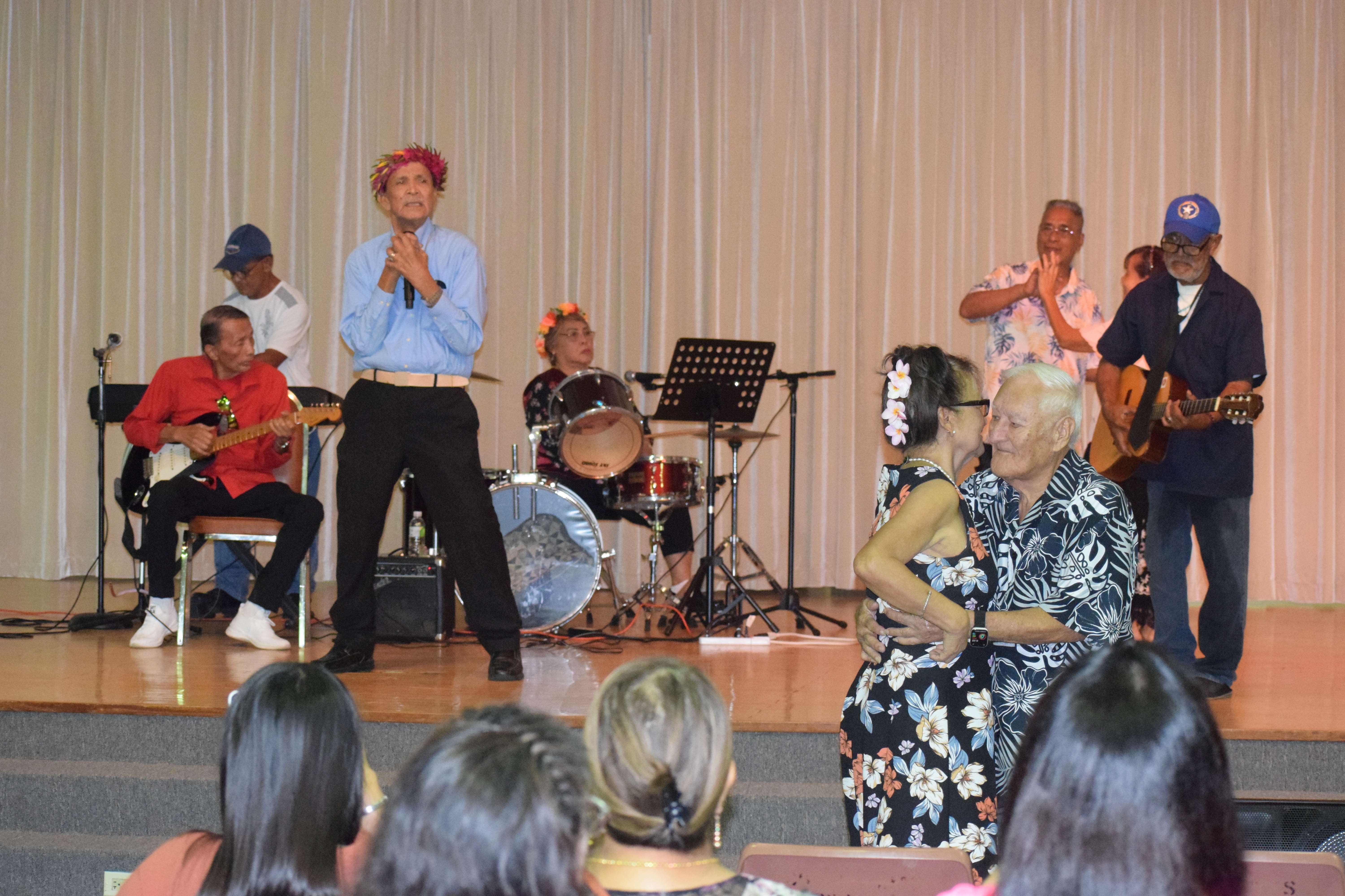 Jess Pangelinan plays the lead guitar, Vicente S. Basa sings, Eden Liwag plays the drums, Juan Agustin is on acoustic guitar while former Rep. Karl Reyes and his wife Virginia dance during the Office on Aging's Manamko' Concert at the multi-purpose center on Friday.