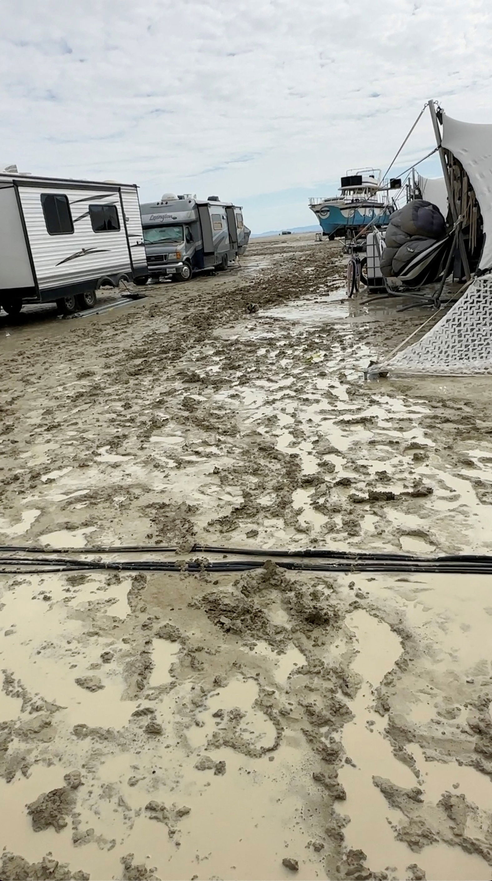 The mud covers the ground at the site of the Burning Man festival in Black Rock, Nevada, U.S., September 2, 2023, in this screen grab obtained from a social media video. Paul Reder/via REUTERS