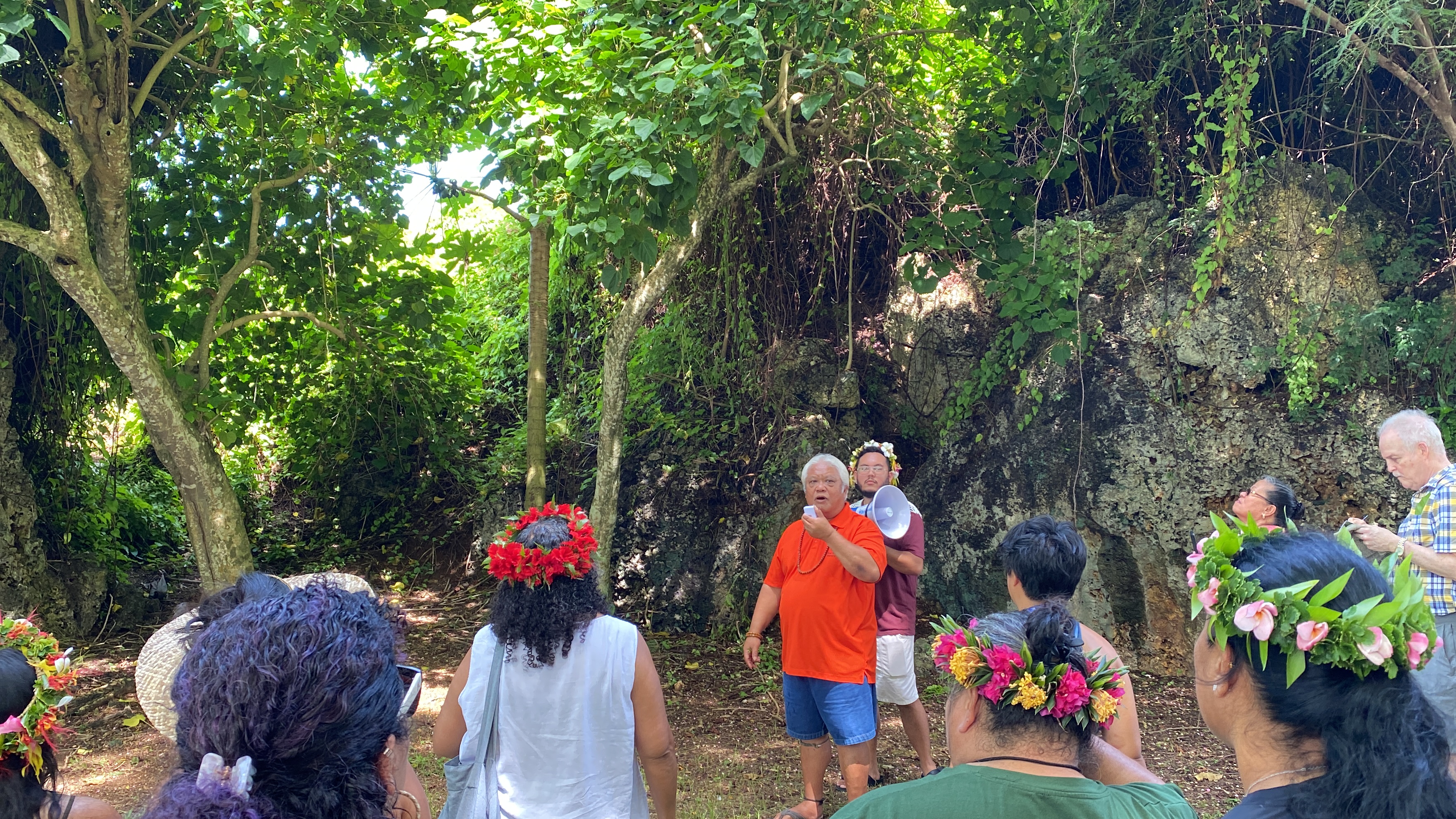Donald Mendiola leads dozens of residents around Paupau Beach as part of the day's activities.