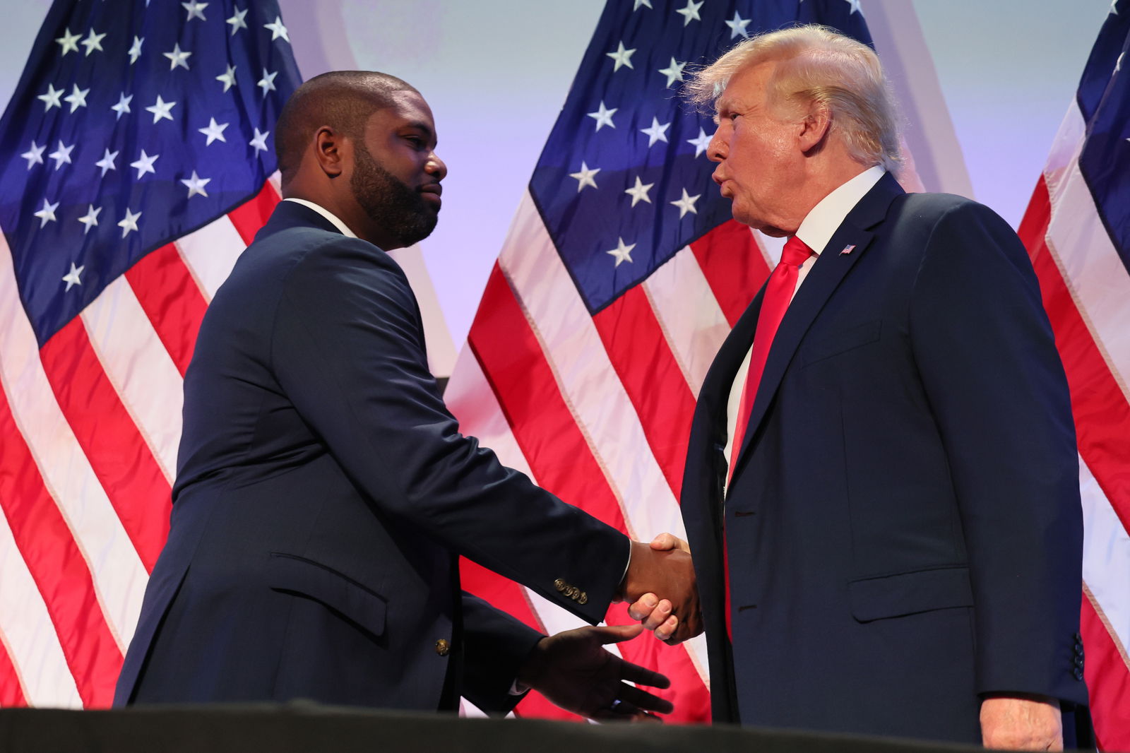 In this photo from June 30, 2023, Rep. Byron Donalds (R-FL) shakes hands with former U.S. President Donald Trump during the Moms for Liberty Joyful Warriors national summit at the Philadelphia Marriott Downtown in Philadelphia, Pennsylvania. The self-labeled "parental rights" summit is bringing school board hopefuls from across the country where attendees will receive training and hear from Republican presidential candidates which include former U.S. President Donald Trump, Florida Gov. Ron DeSantis and former South Carolina Gov. Nikki Haley. The summit, which is being held in an overwhelmingly Democratic Philadelphia, has drawn protestors since the event was announced due to their pushing of book bans accusing schools of ideological overreach, including teaching about race, gender, and sexuality. (Michael M. Santiago/Getty Images/TNS)