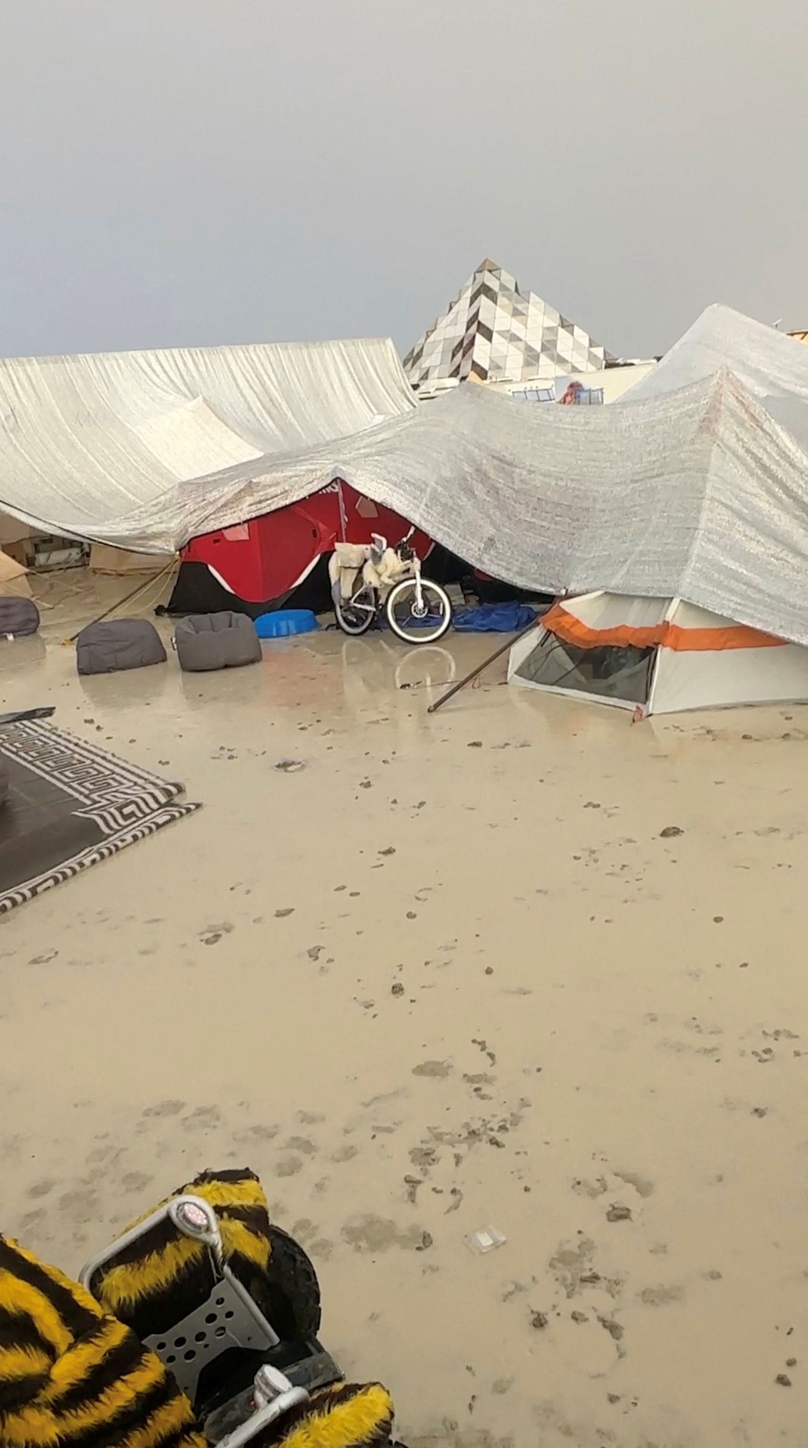 Tents are seen covered to protect them from the rain as the mud covers the ground at the site of the Burning Man festival in Black Rock, Nevada, U.S., September 1, 2023, in this screen grab obtained from a social media video. Paul Reder/via REUTERS