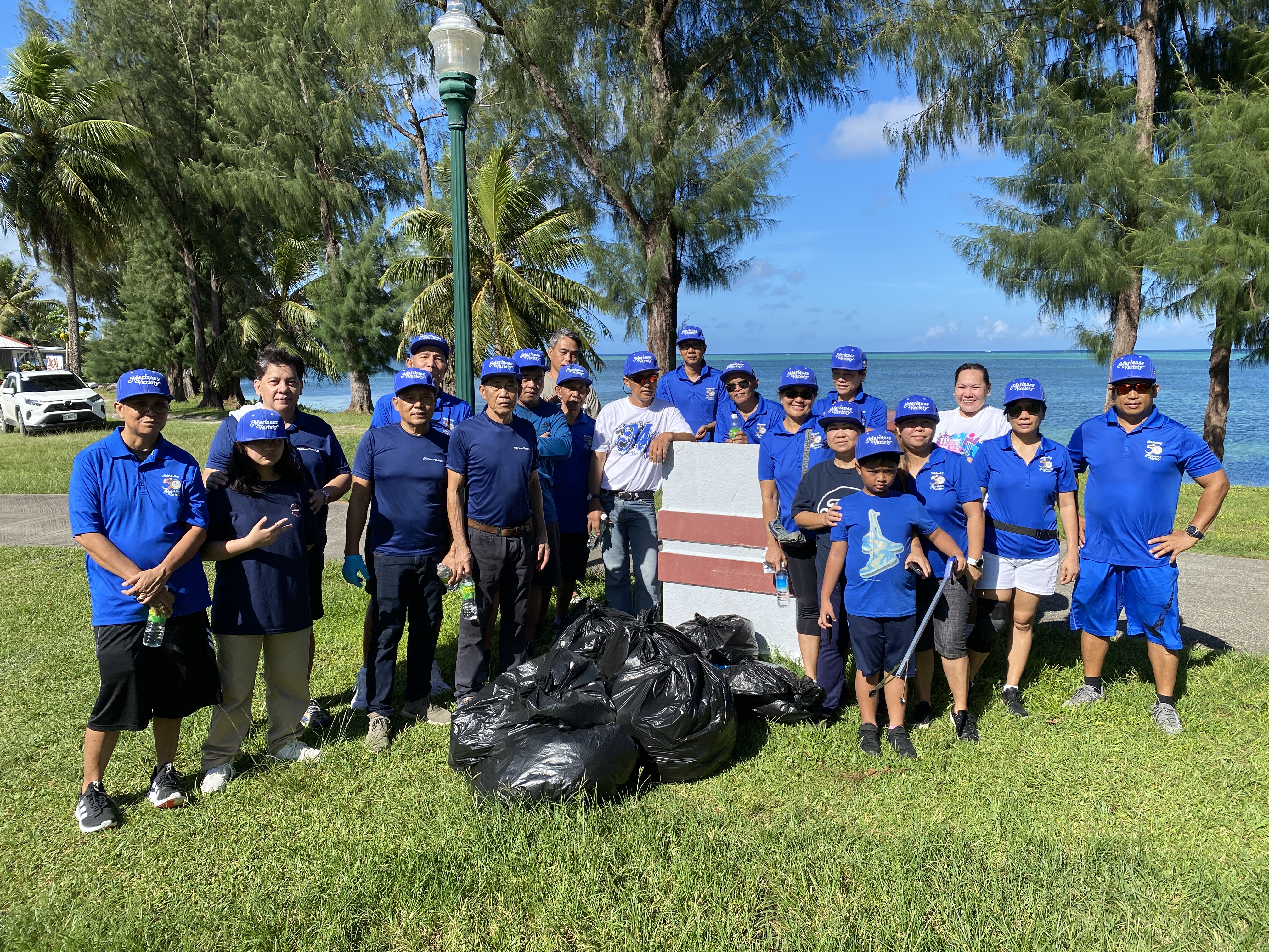 Marianas Variety staff members pose for a photo after cleaning up the area from Oleai Beach Bar & Grill  to the Quartermaster intersection.