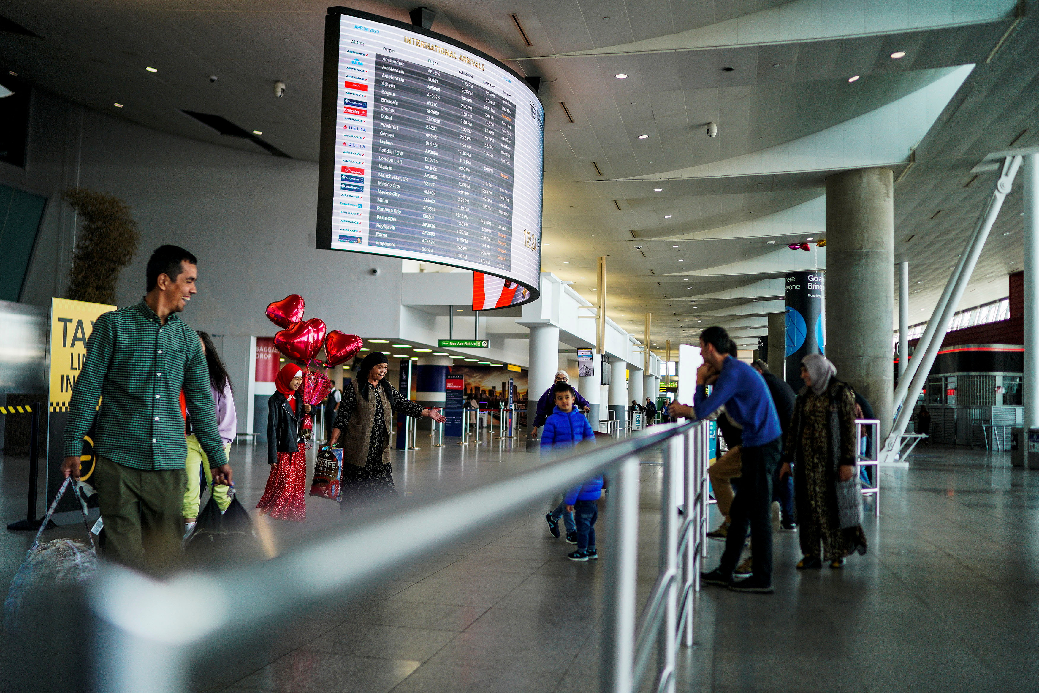 Travelers arrive at John F. Kennedy International Airport in New York City, U.S., April 6, 2023. 