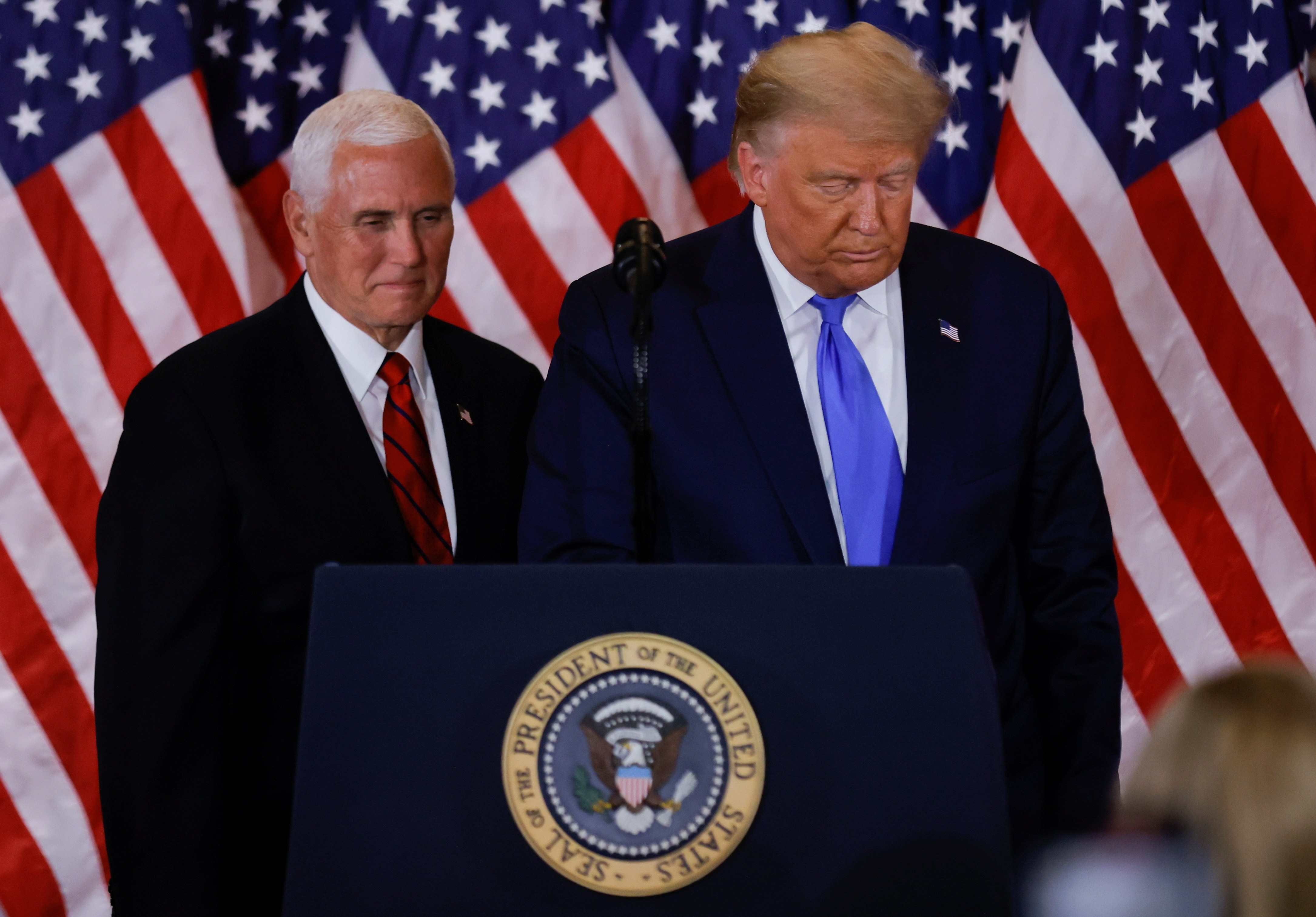 U.S. President Donald Trump and Vice President Mike Pence stand while making remarks about early results from the 2020 U.S. presidential election in the East Room of the White House in Washington, U.S., November 4, 2020. REUTERS/Carlos Barria
