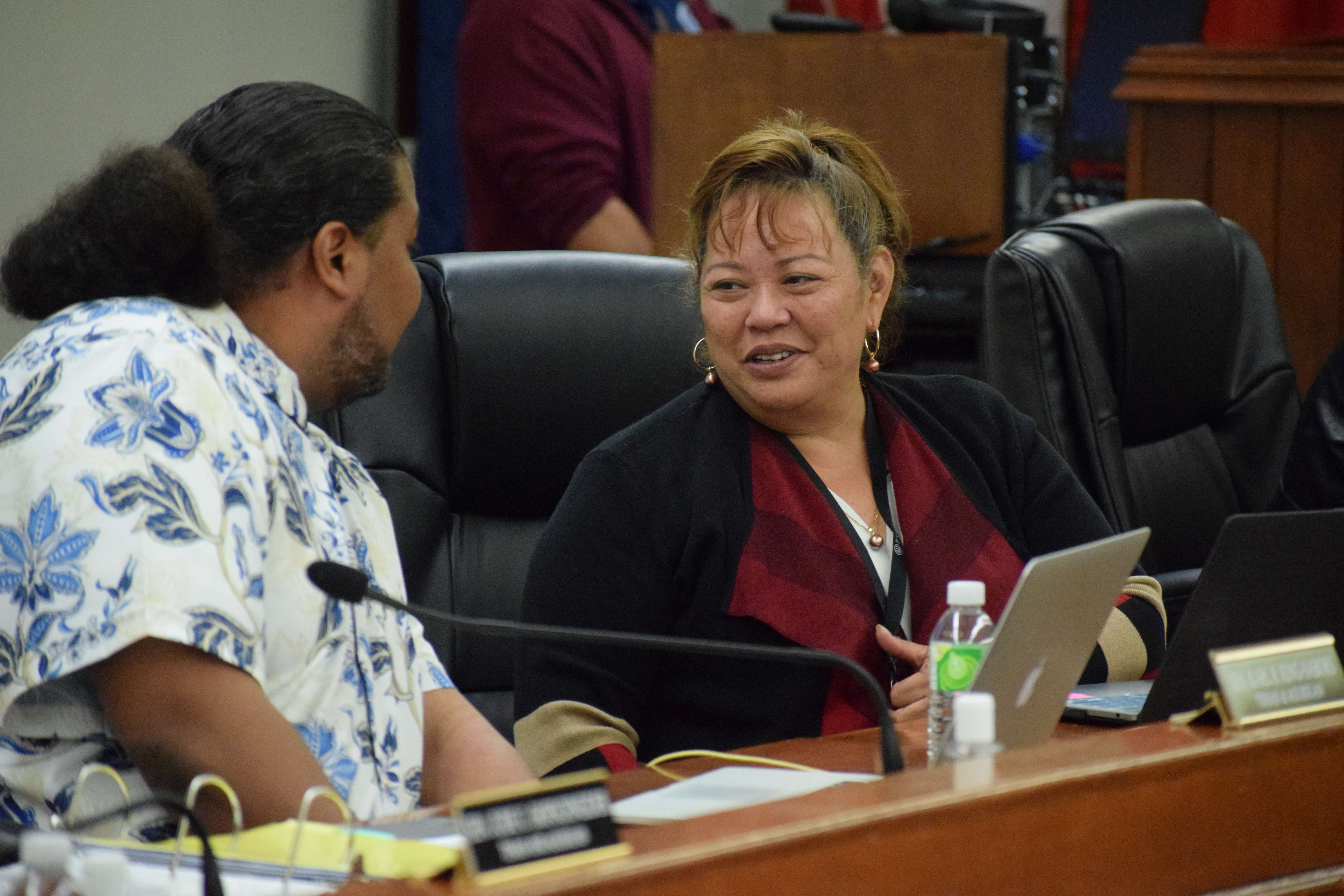 Sen. Celina Babauta, right, talks with Sen. Karl King-Nabors during a break from a Senate session on Thursday.