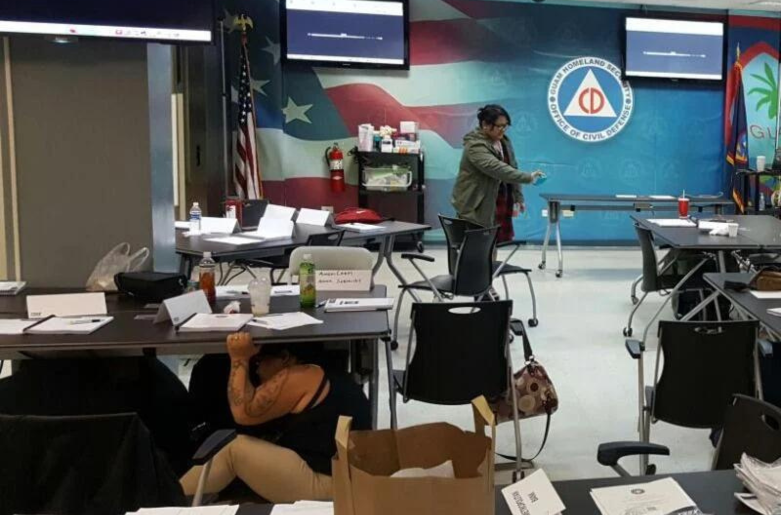 In this file photo contributed in 2016, participants in a training session at the offices of Guam Homeland Security and Civil Defense practice sheltering and holding on during the Great Guam Shakeout earthquake drill.