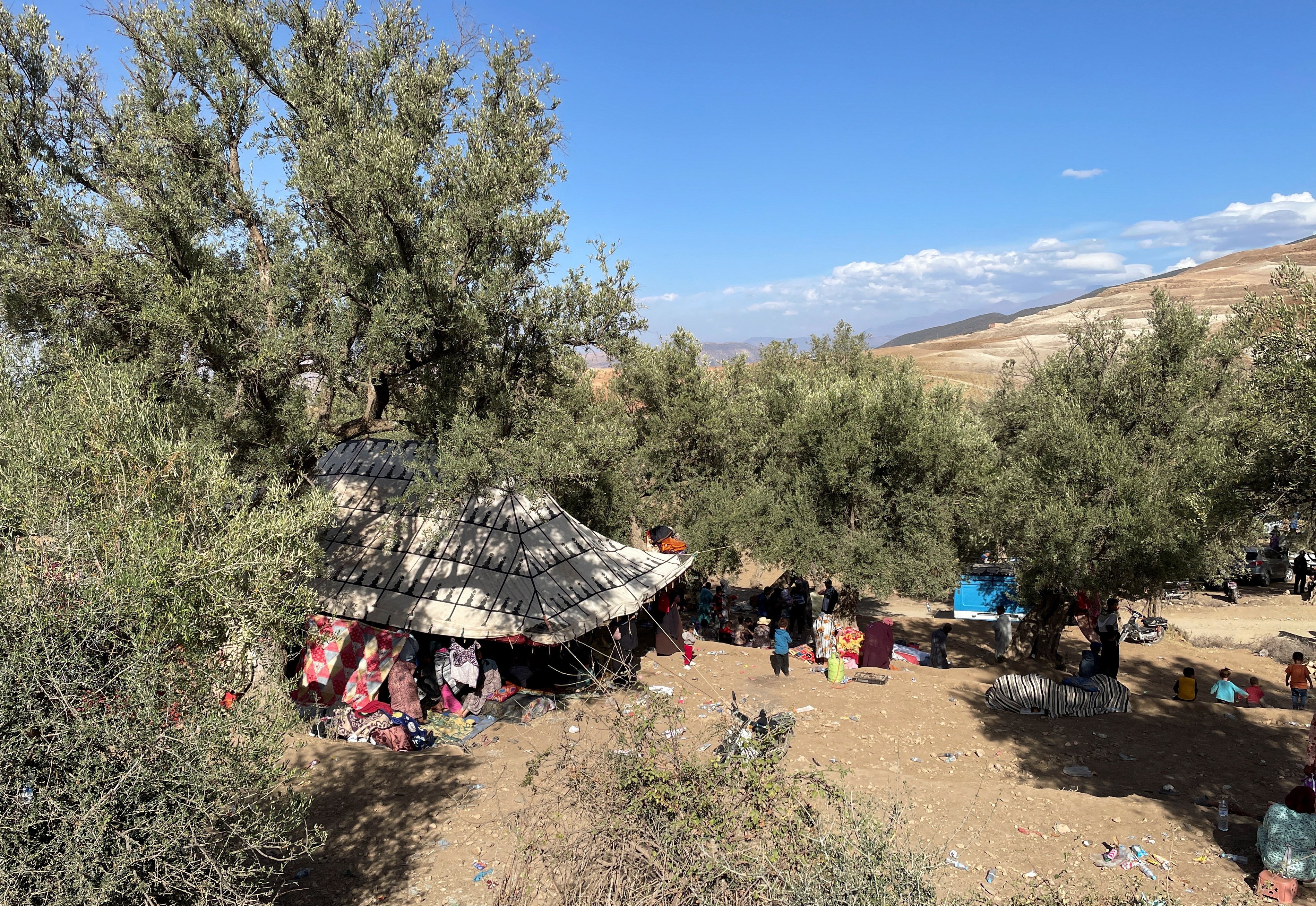 Families take shelter under a tent in Tafeghaghte, a remote village of the High Atlas mountains, following a powerful earthquake in Morocco, September 10, 2023. REUTERS/Ahmed El Jechtimi