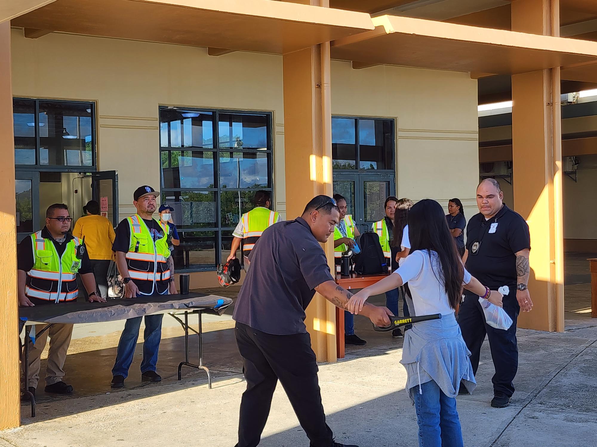 School officials and Department of Public Safety personnel conduct security screenings at are Chacha Ocean View Middle School Friday morning.