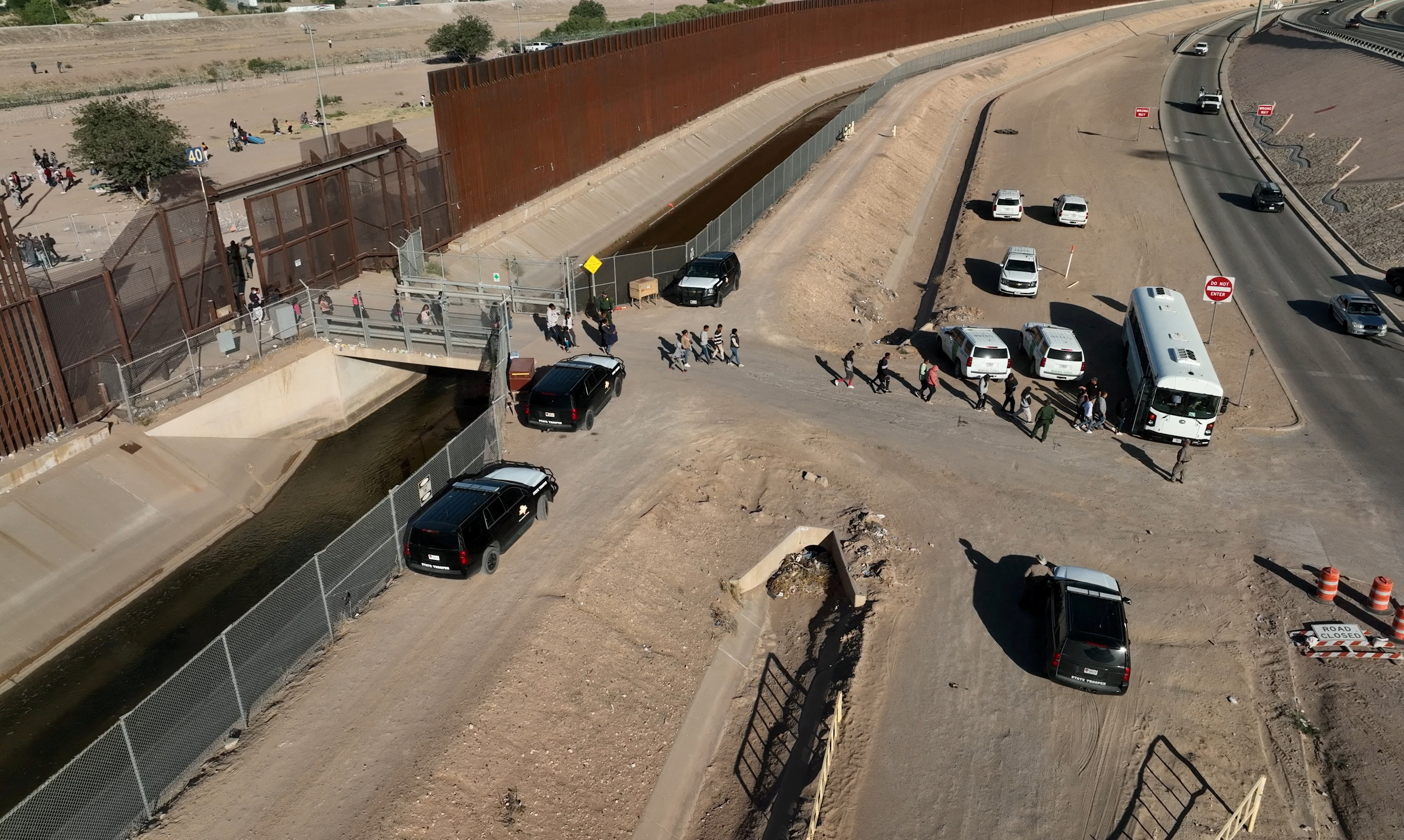 Migrants line up to board a U.S. Customs and Border Patrol bus after crossing the U.S.-Mexico border before the lifting of Title 42 near El Paso, Texas, U.S., May 11, 2023. 
