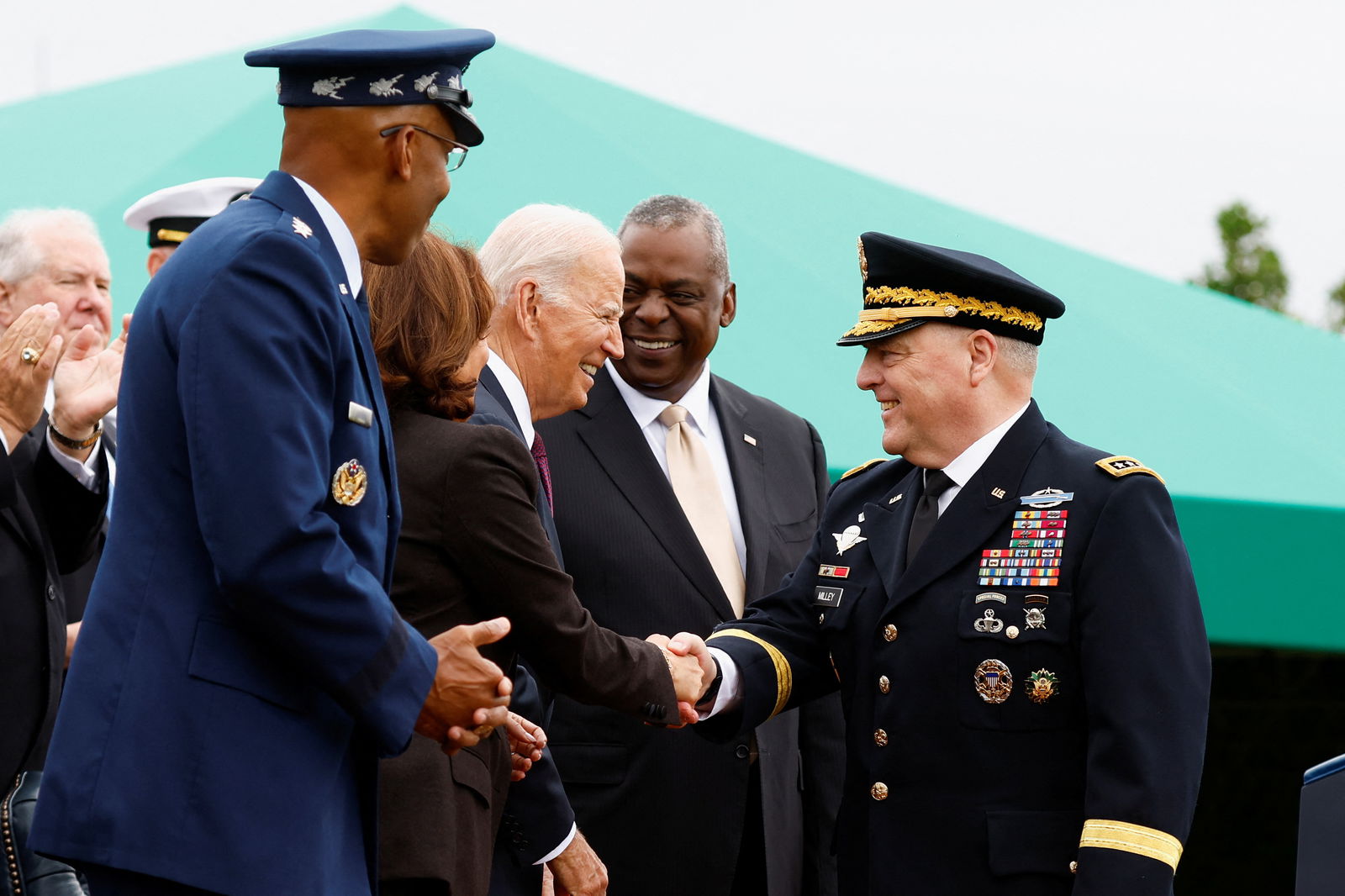 20th Chairman of the Joint Chiefs of Staff General Mark A. Milley shakes hands with U.S. President Joe Biden, as Vice President Kamala Harris, U.S. Secretary of Defense Lloyd Austin and 21st Chairman of the Joint Chiefs of Staff General Charles Q. Brown, Jr. react, on the day of the Armed Forces Farewell Tribute in honor of General Milley and an Armed Forces Hail in honor of General Brown, at Summerall Field at Joint Base Myer-Henderson Hall, Arlington, Virginia, U.S., September 29, 2023. 