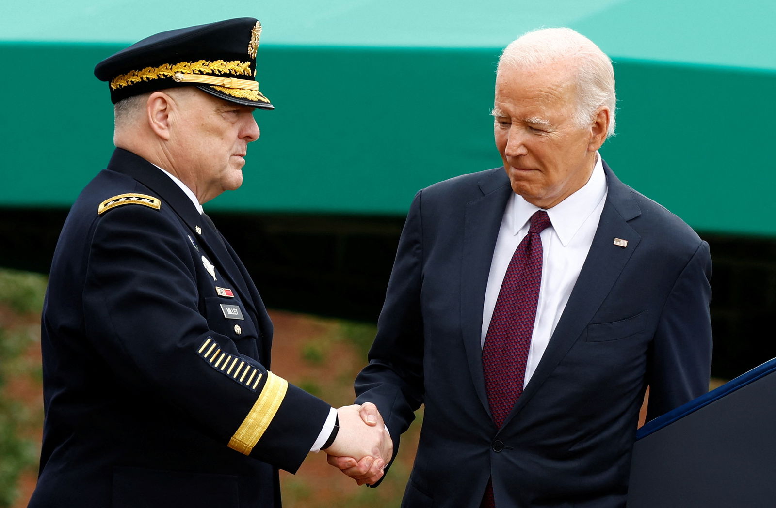 U.S. President Joe Biden shakes hands with General Mark A. Milley, 20th Chairman of the Joint Chiefs of Staff during the Armed Forces Farewell Tribute in his honor and Armed Forces Hail in honor of General Charles Q. Brown, Jr., the 21st Chairman of the Joint Chiefs of Staff at Summerall Field at Joint Base Myer-Henderson Hall, Arlington, Virginia, U.S., September 29, 2023. 