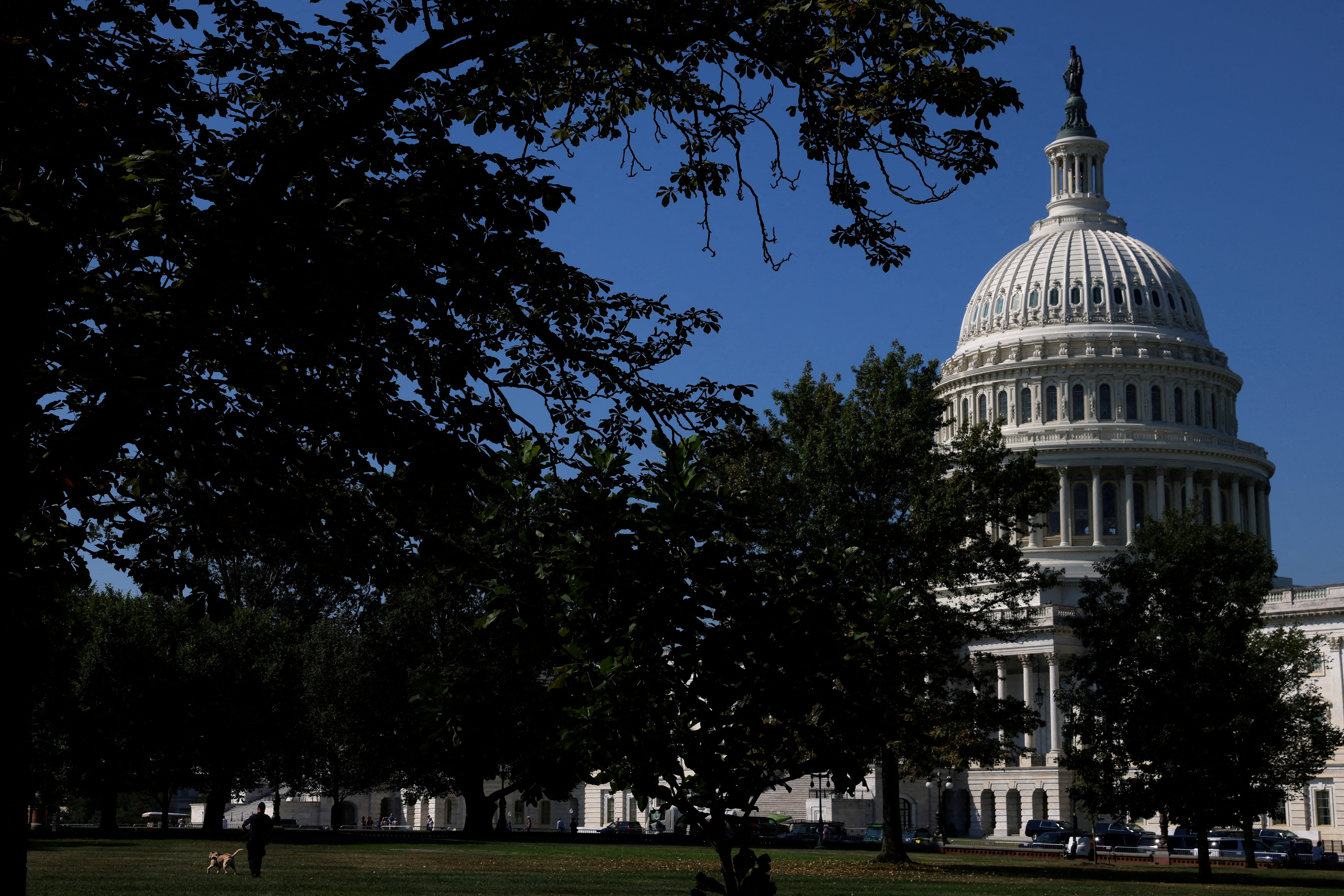 A U.S. Capitol Police Officer walks a K-9 dog in front of the Capitol amid talks over government funding, as the threat of an October government shutdown looms on Capitol Hill in Washington, U.S., September 6, 2023. 