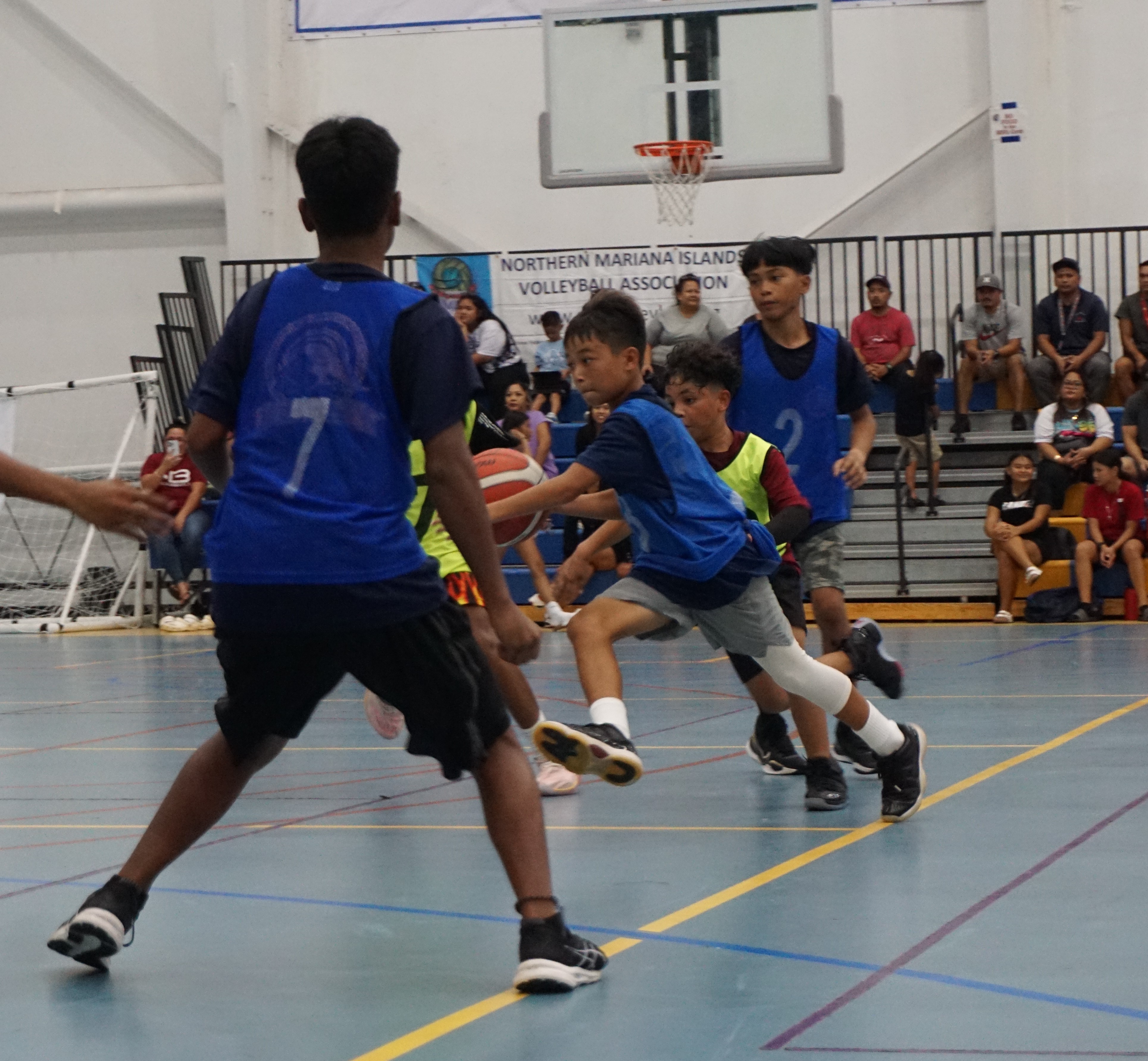Hopwood Middle School's Jequinn Lizama attempts to dribble in between defenders during a boys middle school division game of the IT&E-PSS Interscholastic Basketball League at the MHS gym.