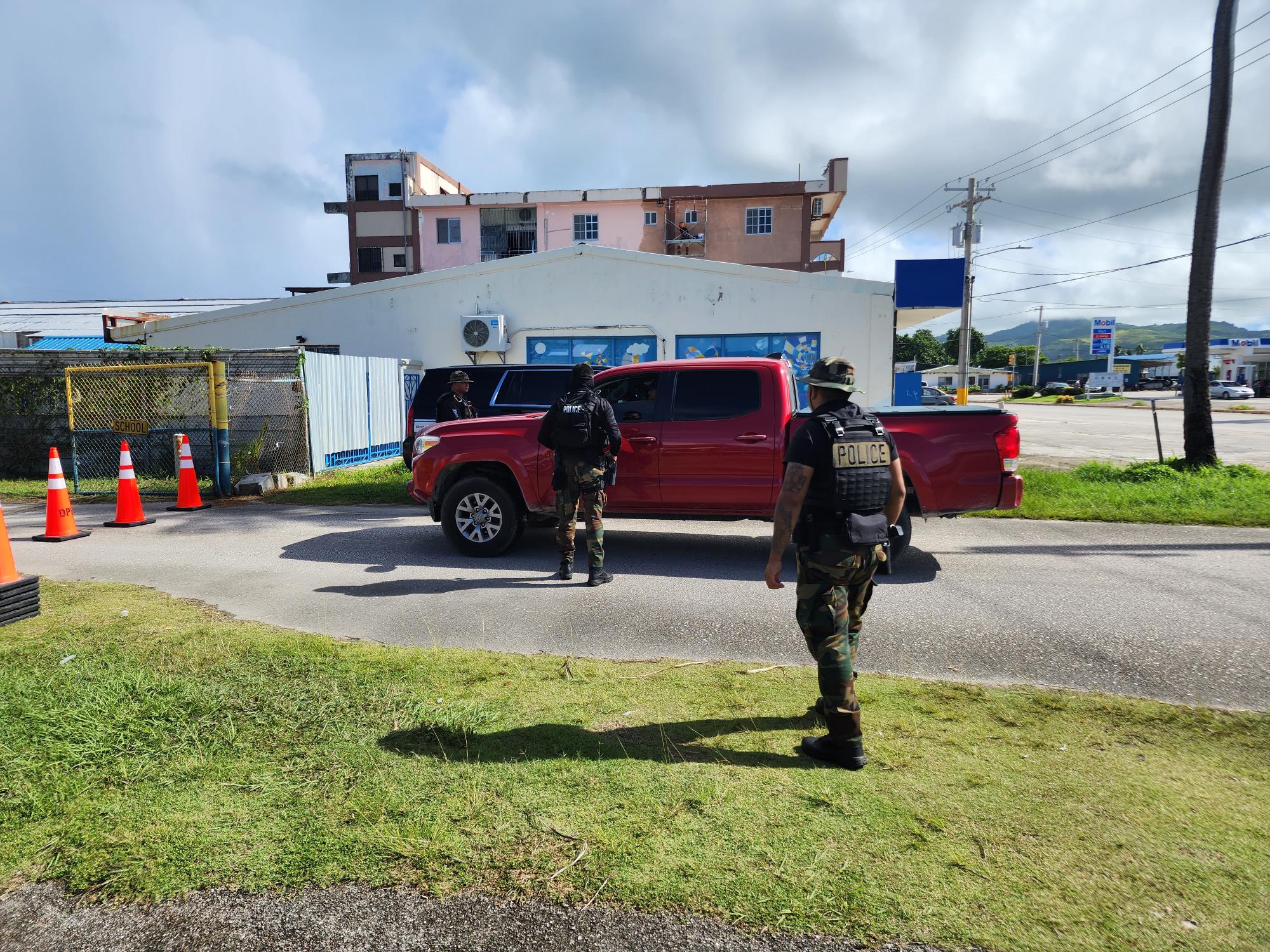 DPS-Rapid Response Team members inspect a red pick-up truck that was about to enter Hopwood Middle School on Monday morning.