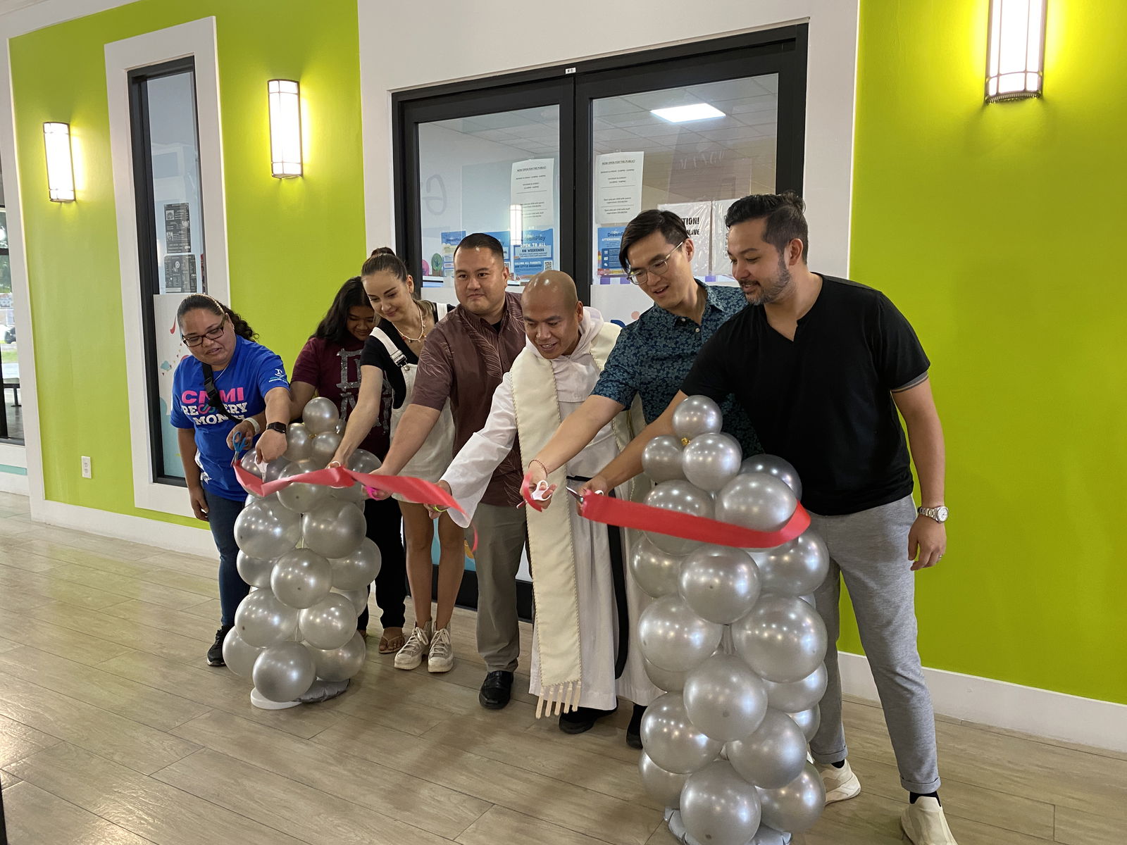 Florence Pacia, teacher aide; Melva Mafnas, teacher aide; Anastasia Inos, DreamPlay director; Rep. Manny Castro; Father Enrico Nacorda; Michael Sheu, co-owner; and Perry Inos Jr. co-owner cut the ceremonial ribbon during the official opening of DreamPlay in Chalan Kanoa.