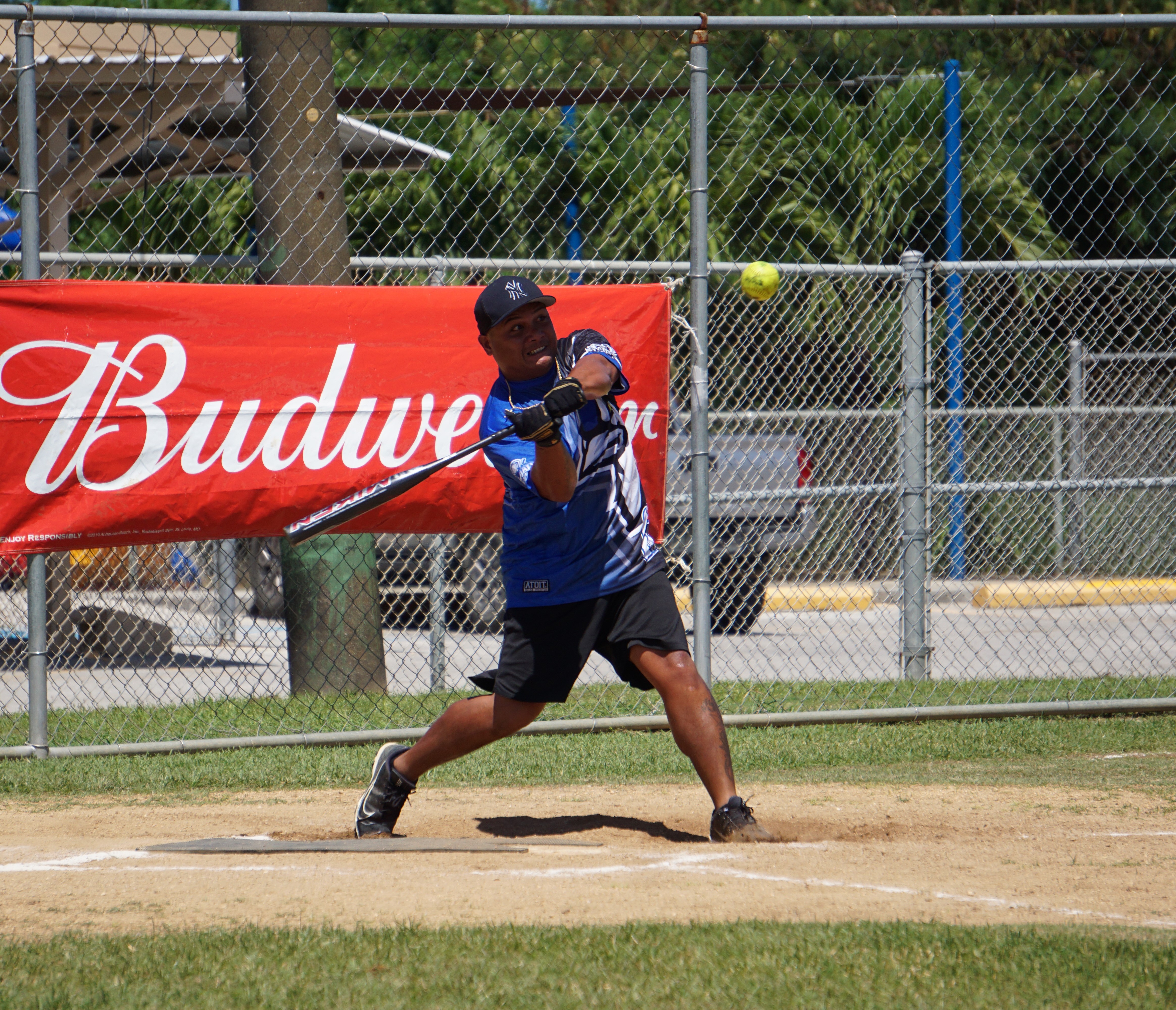 Blue Jays' EJ Cabrera swings and connects a single during a game in the 2023 Budweiser Belau Amateur Softball Association Open League at the Dandan baseball field.
