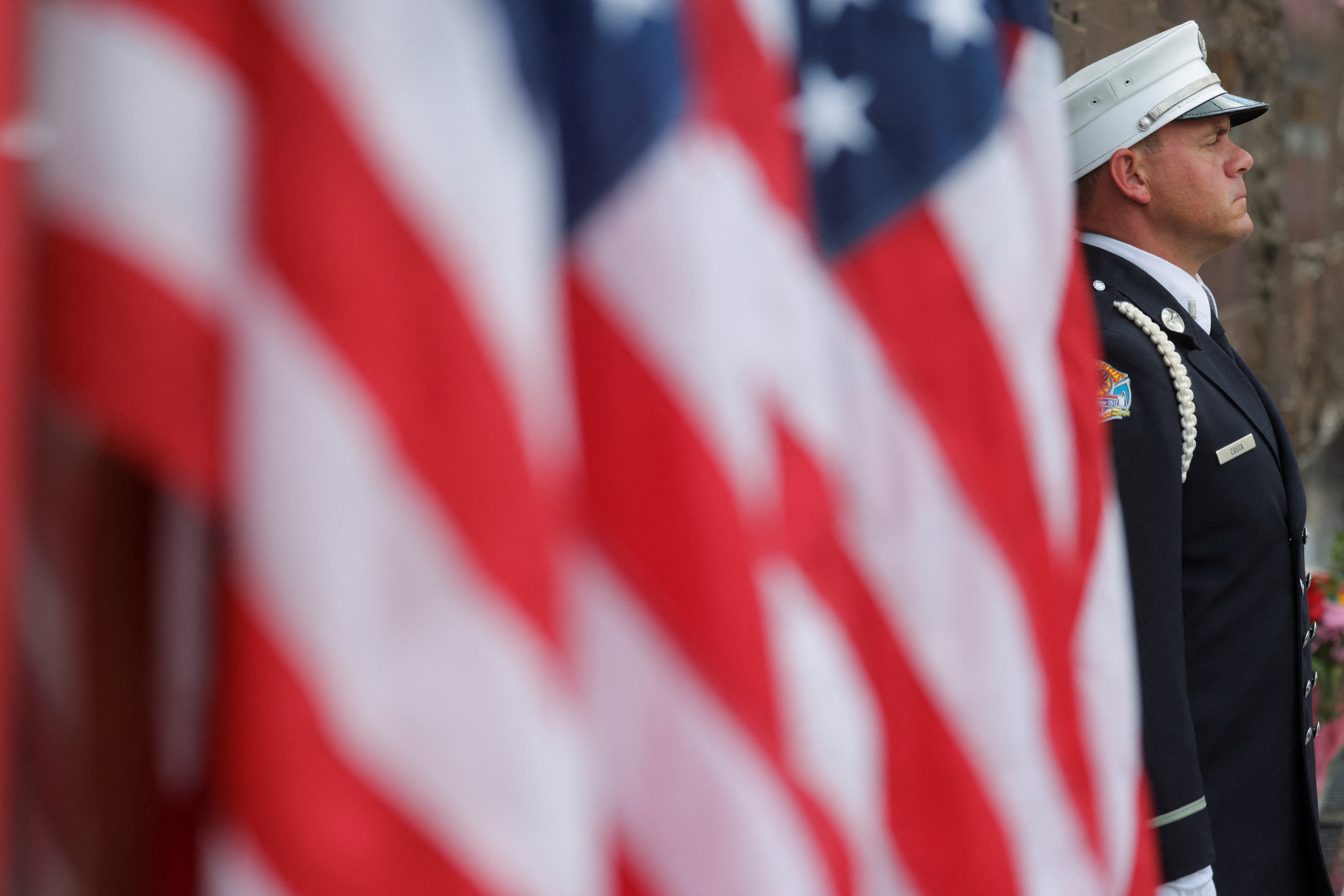 A New York City Fire Department firefighter stands at the Firefighter memorial, on the day of the 22nd anniversary of the September 11, 2001 attacks on the World Trade Center, in New York City, U.S., September 11, 2023. 