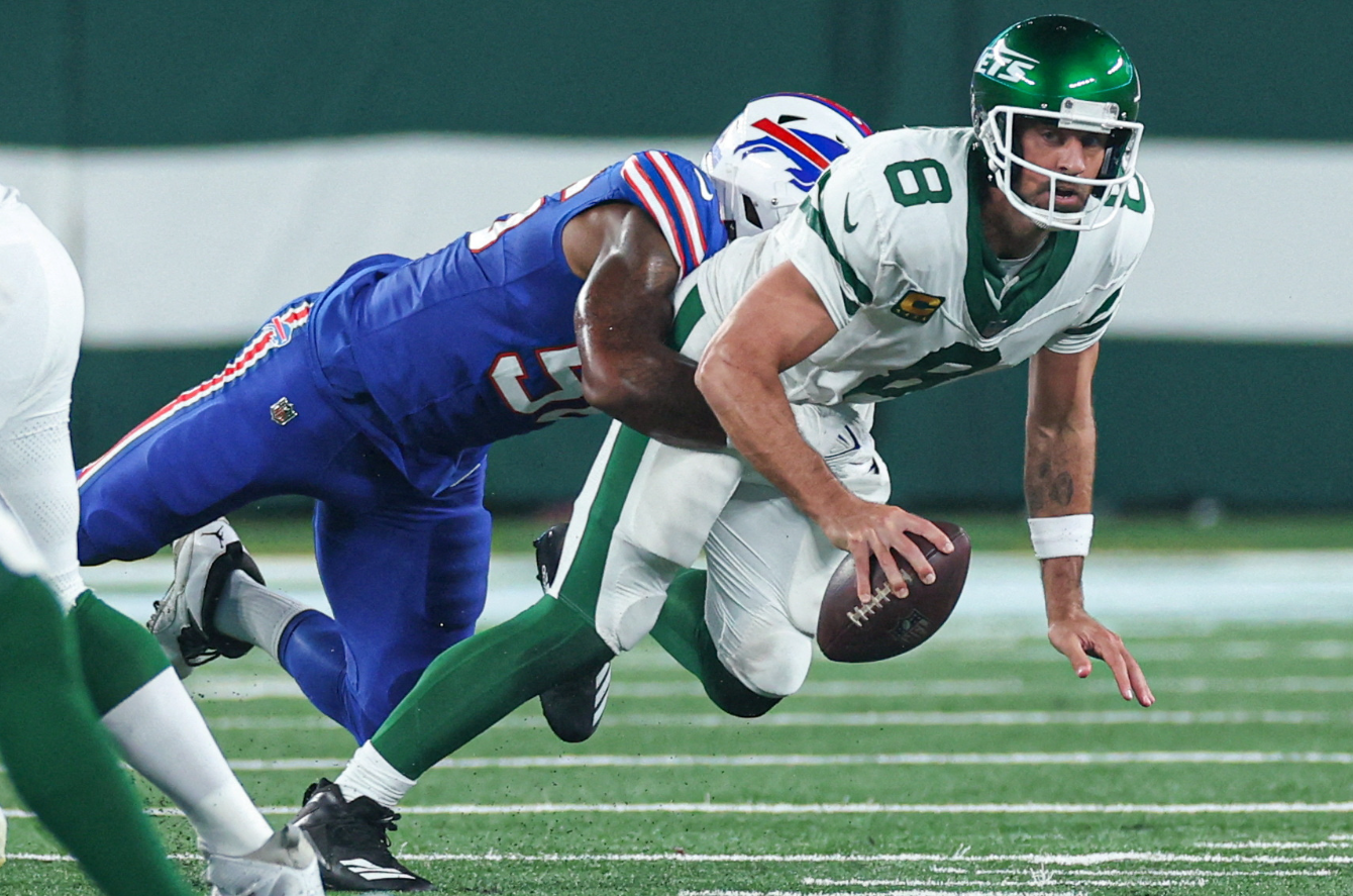 New York Jets quarterback Aaron Rodgers (8) is injured while being sacked by Buffalo Bills defensive end Leonard Floyd (56) during the first half at MetLife Stadium in East Rutherford, New Jersey, Sept. 11, 2023.