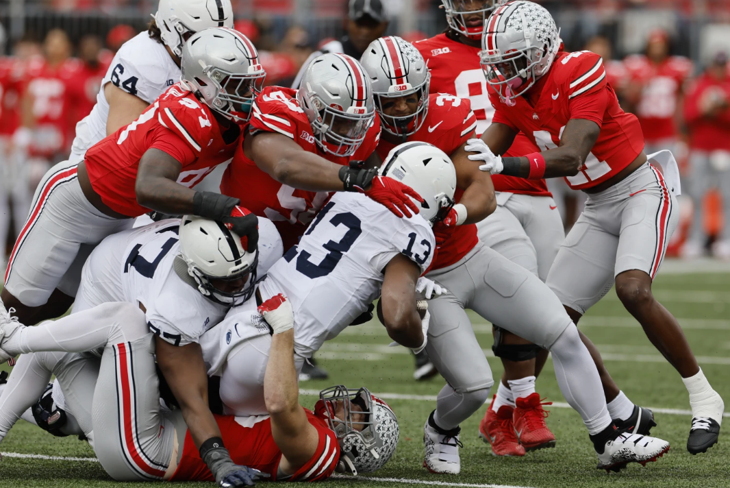 Ohio State defenders tackle Penn State running back Kaytron Allen during the first half of an NCAA college football game Saturday, Oct. 21, 2023, in Columbus, Ohio.