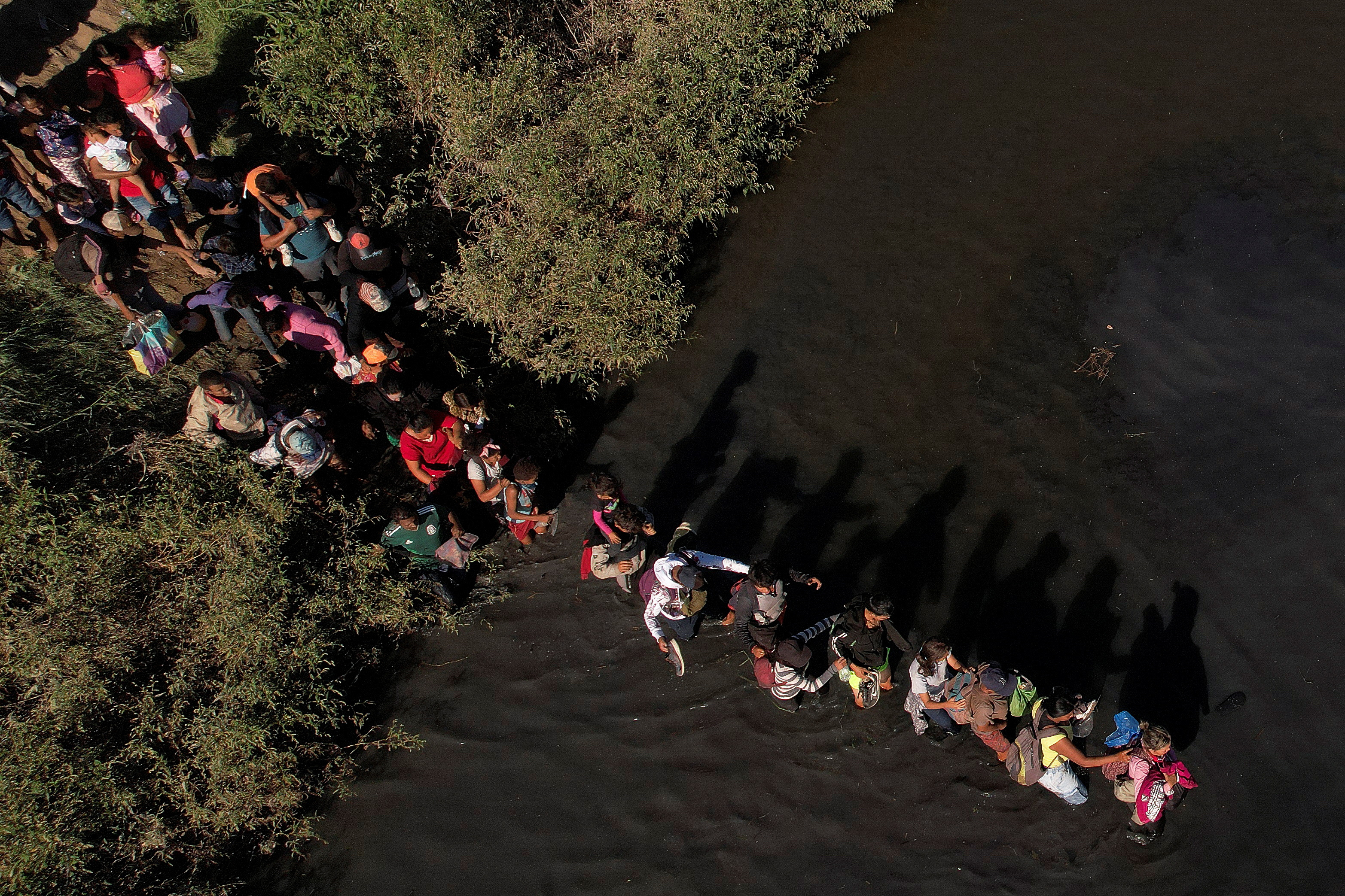 Migrants, who were stranded a day earlier near Villa Ahumada, and who are seeking asylum in the United States, cross the Rio Bravo river, as seen from Ciudad Juarez , Mexico September 30, 2023. 