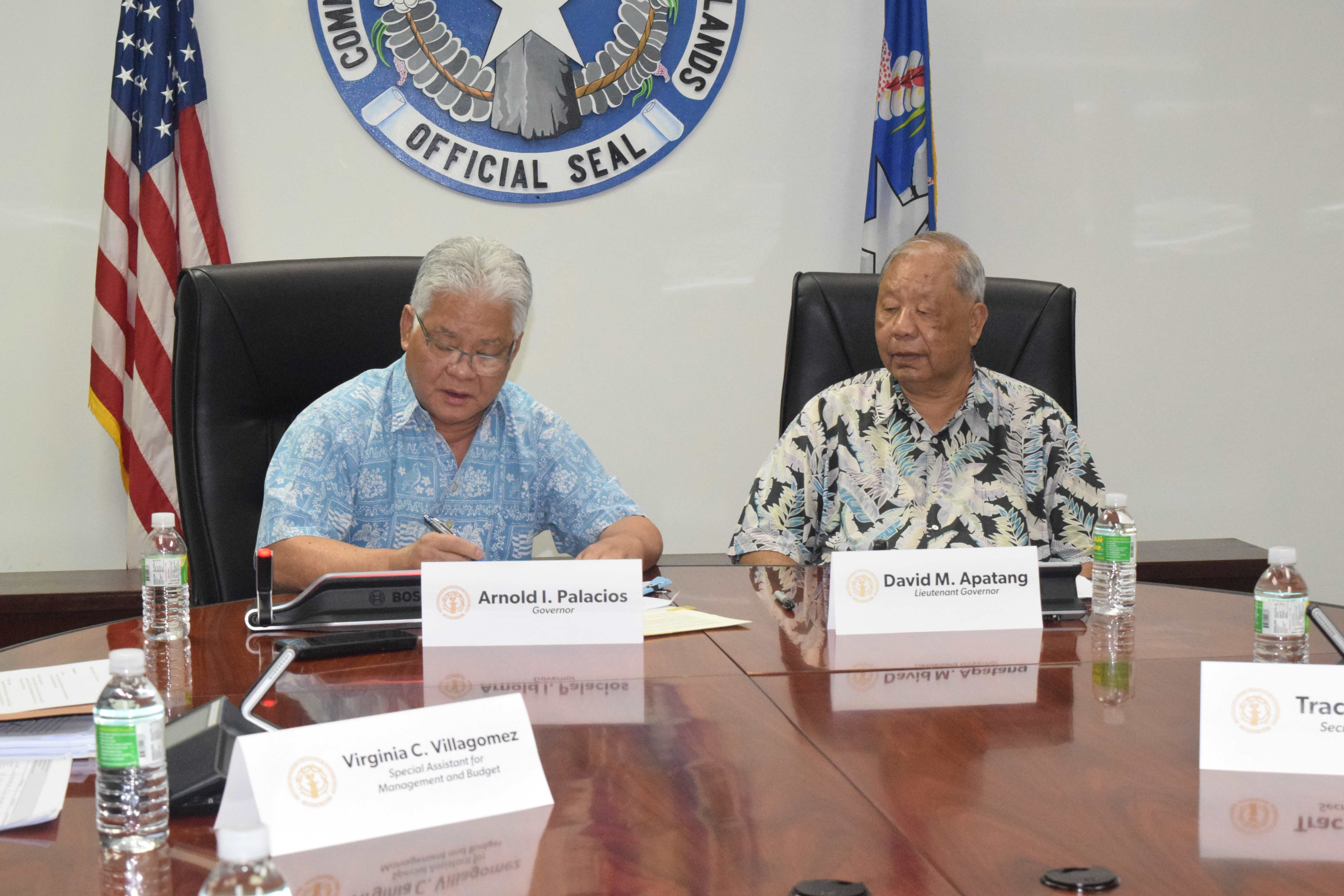 Gov. Arnold I. Palacios signs the Fiscal Year 2024 Appropriation Act as Lt. Gov. David M. Apatang looks on in the governor's conference room on Sept. 30, 2023.