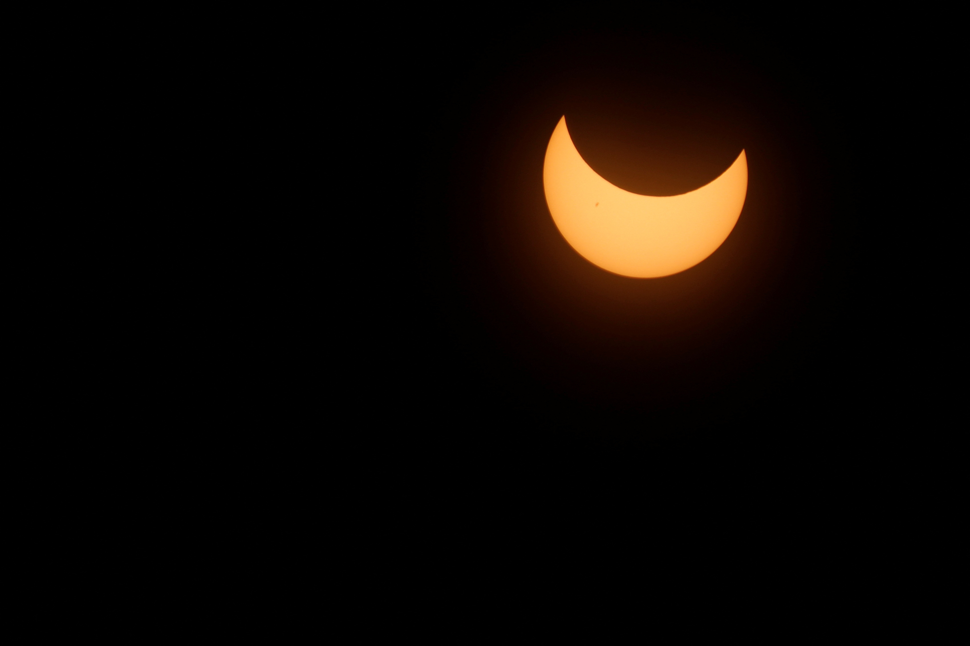 A solar eclipse is seen from the Bicentenario Park in Antiguo Cuscatlan, El Salvador October 14, 2023. REUTERS/Jose Cabezas