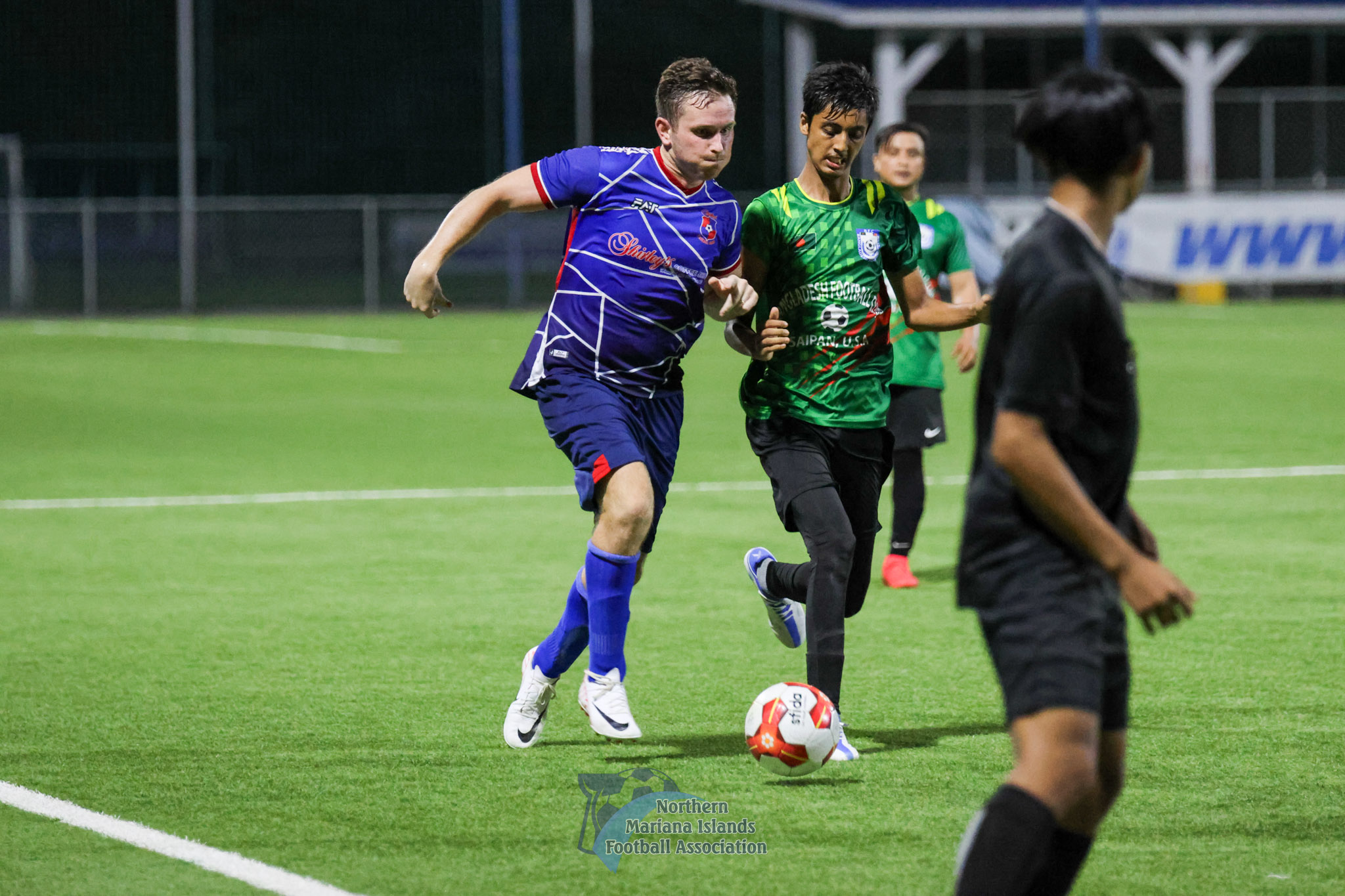 A Shirley's Football Club 2 and Bangladesh Football Club player battle for the possession during a Marianas Soccer League 2 game at the NMI Soccer Training Center