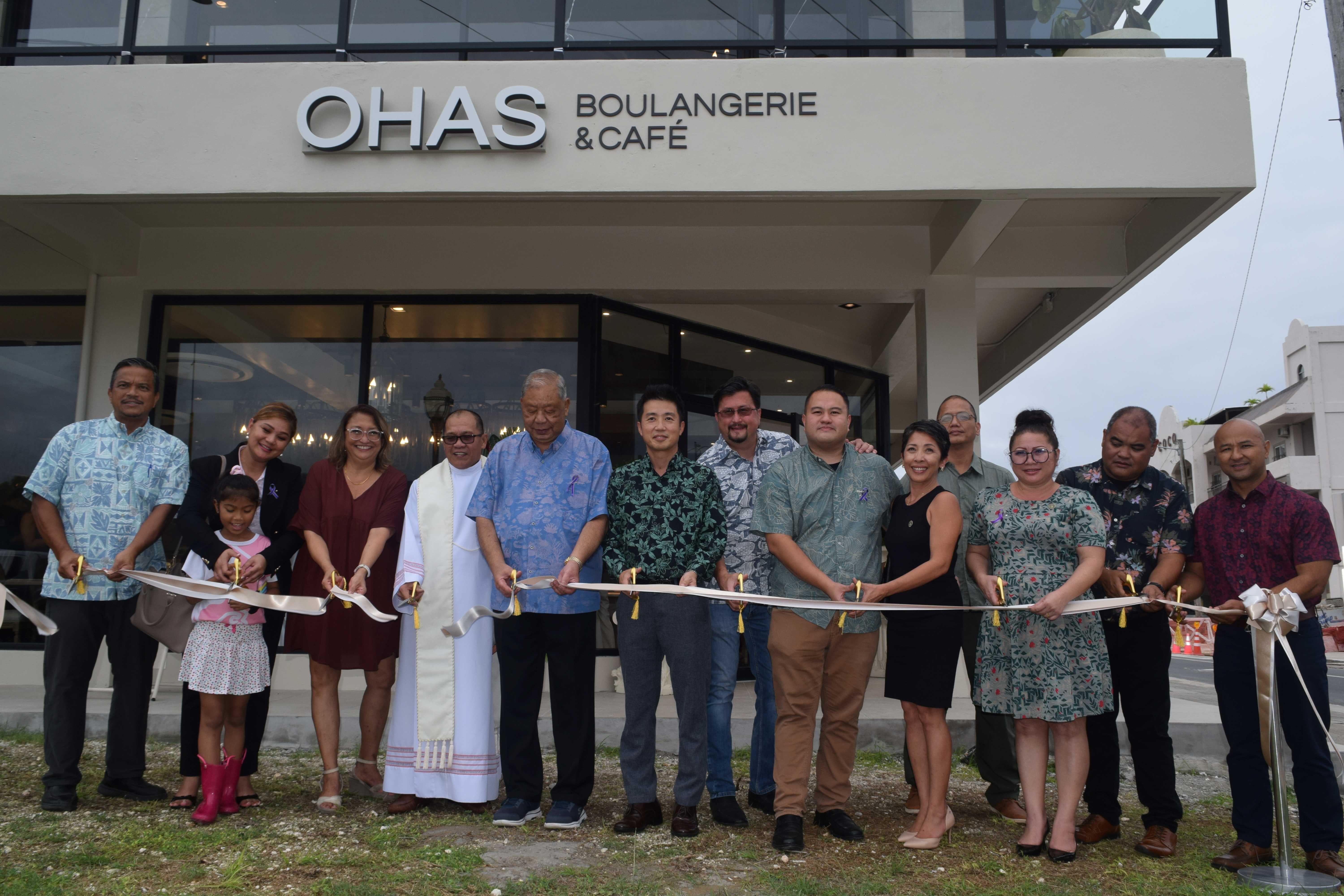 Lt. Gov. David M. Apatang, fifth left, and E-Land CEO Brian Shin, center, with other CNMI officials cut the ceremonial ribbon to mark the opening of Ohas Boulangerie & Café.