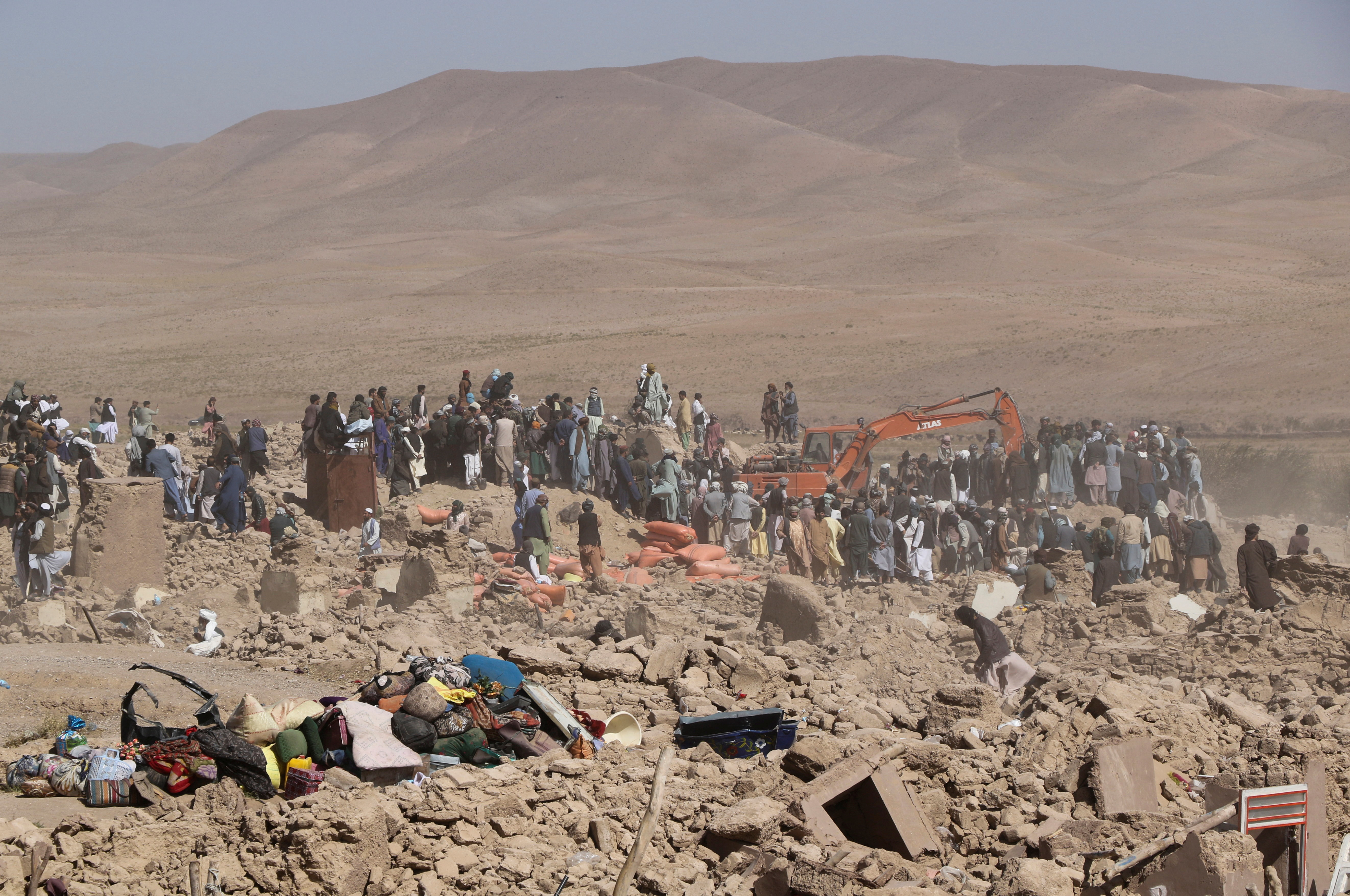 People search for survivors amidst the debris of a house that was destroyed by an earthquake in the district of Zendeh Jan, in Herat, Afghanistan, October 8, 2023. 