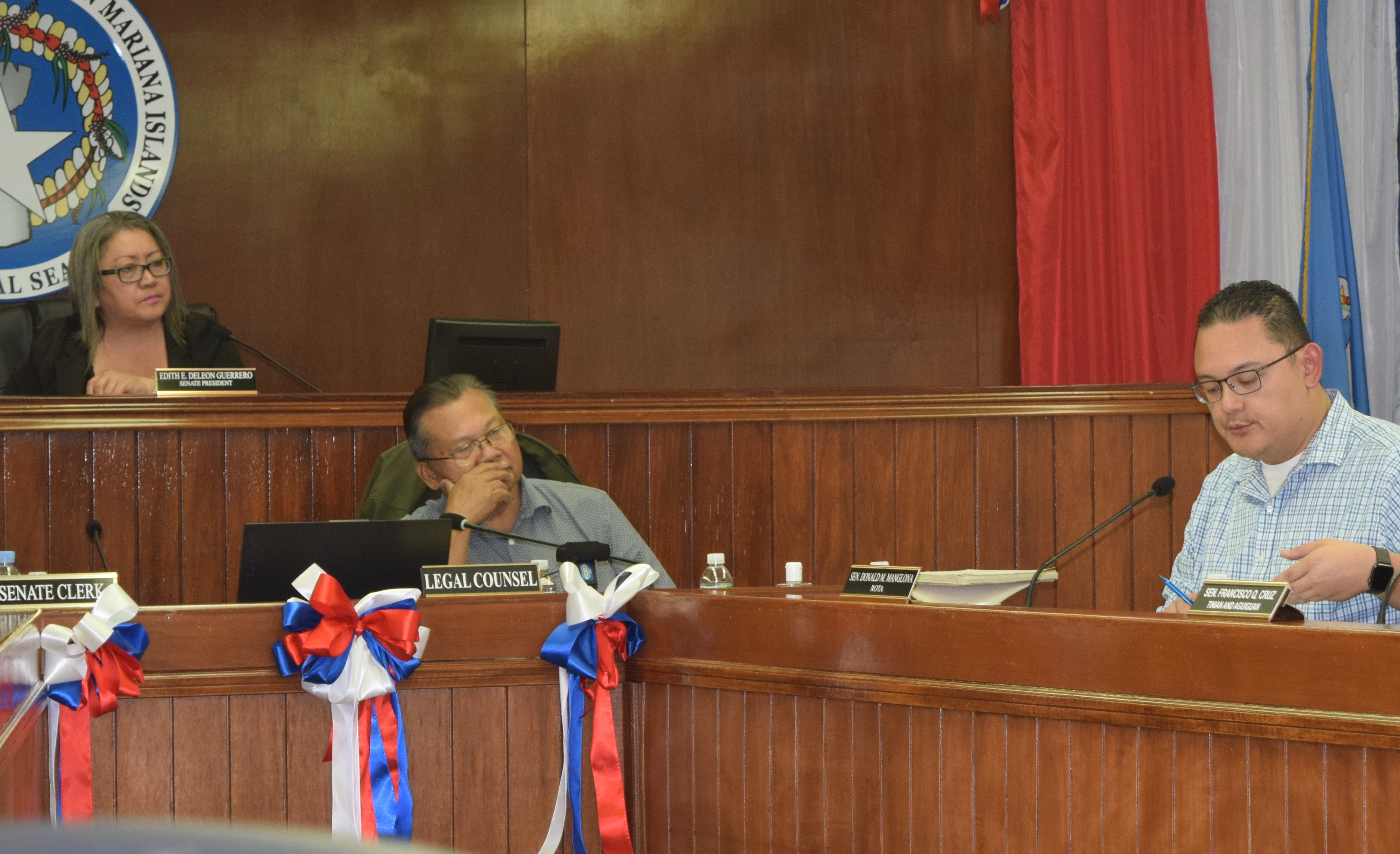 Senate President Edith Deleon Guerrero, left, and Senate legal counsel Jose Bermudes, center, listen as Senate Vice President Donald Manglona speaks during a Senate session.