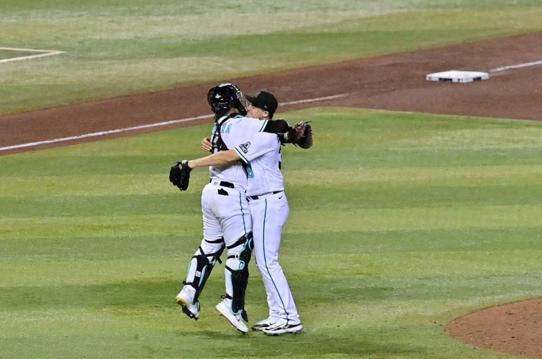 Arizona Diamondbacks relief pitcher Paul Sewald (38) reacts with catcher Jose Herrera (11) after defeating the Los Angeles Dodgers in game three of the NLDS for the 2023 MLB playoffs at Chase Field in Phoenix, Arizona, Oct. 11, 2023.