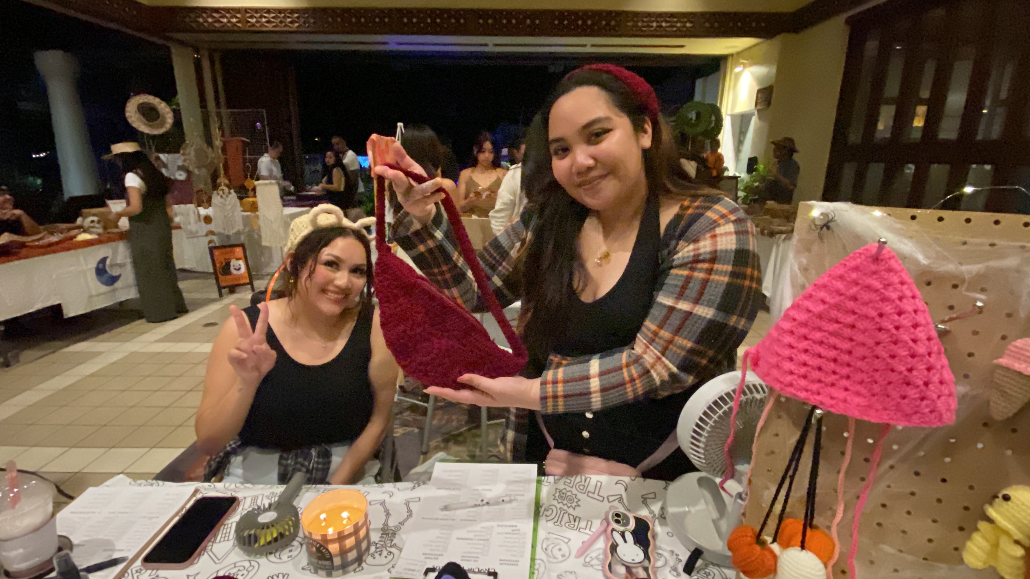 Jemimah Colegio, right, holds a fanny pack she made for her brand, Crochetsaurus.