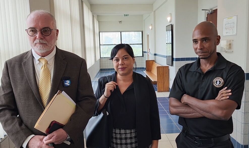 Assistant Attorneys General Steve Kessell and Heather Barcinas with Chief Prosecutor Chester Hinds.