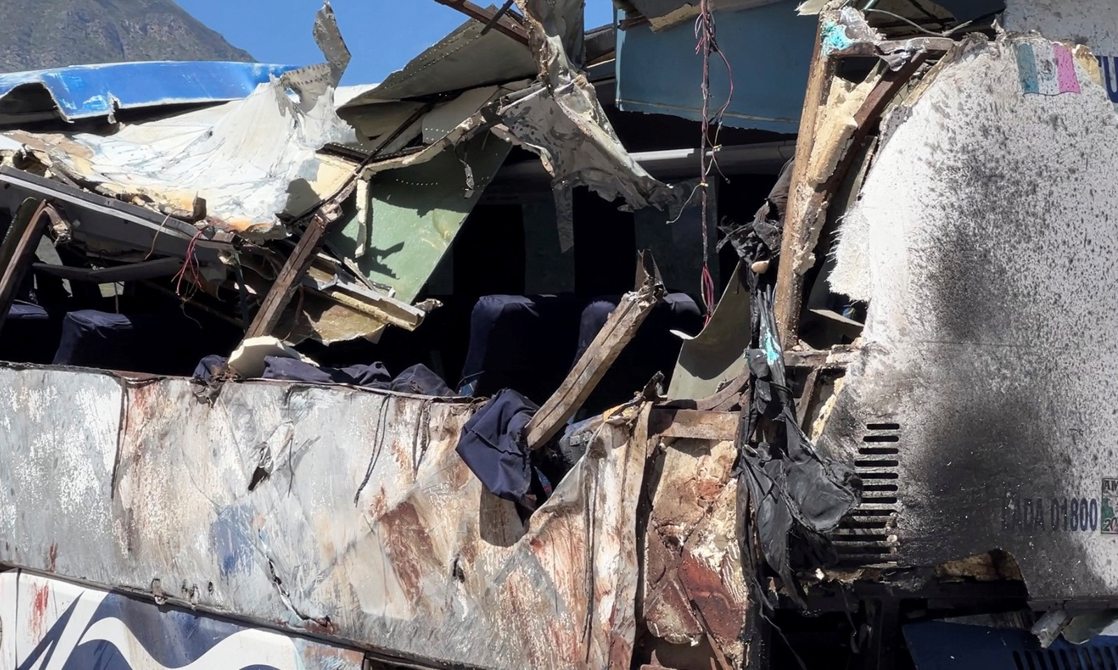 A general view shows a damaged part of a bus, on the scene of a road accident, after a bus carrying dozens of mostly Venezuelan migrants crashed, which left some of the passengers dead and wounded others, on the highway near Tepelmeme Villa de Morelos, in the southern state of Oaxaca, Mexico October 6, 2023. 