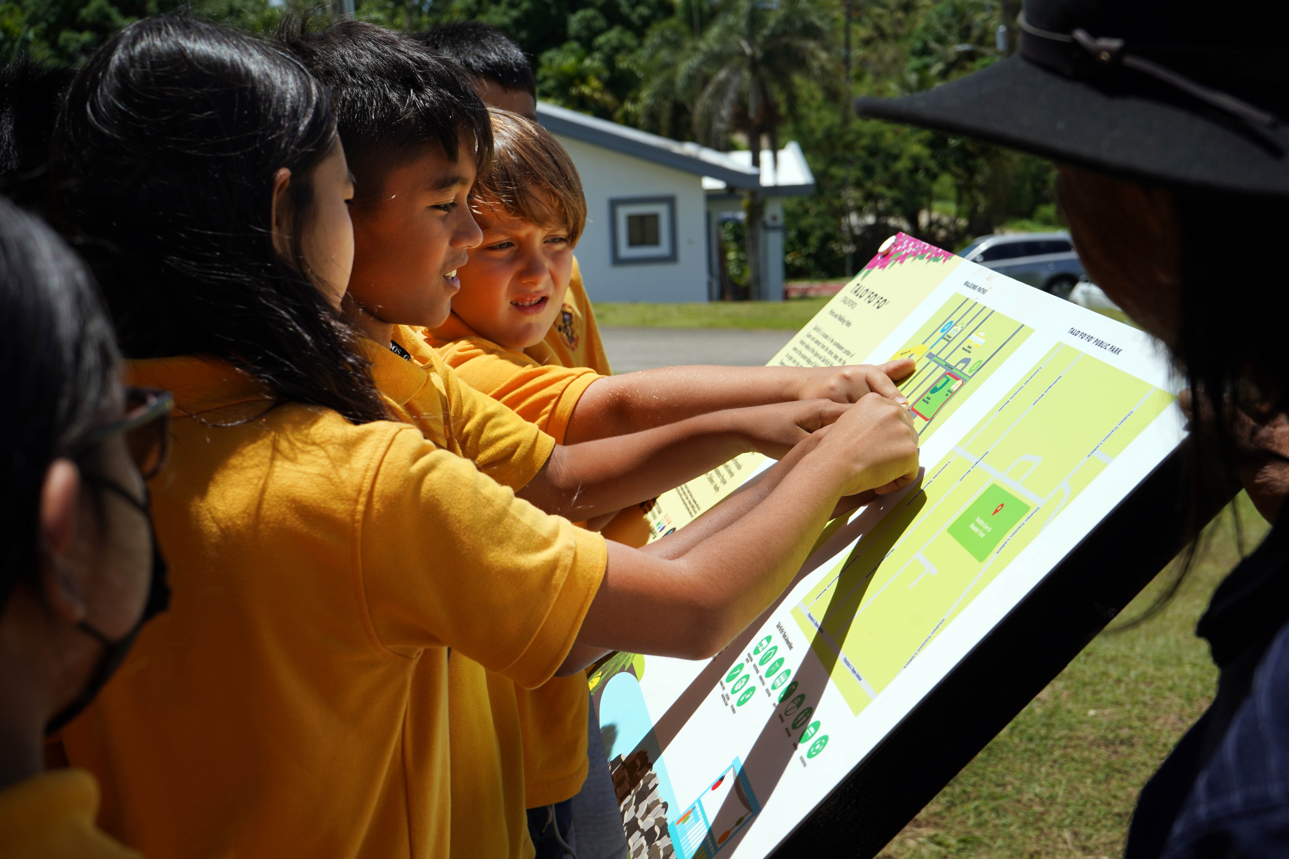 Talo’fo’fo’ Elementary School students point to different walking route options on a newly installed map near their school and the Talo’fo’fo’ Baseball Field. The map, created by the Community Nutrition Education Program and Children’s Healthy Living Program at the University of Guam and installed by the Talo’fo’fo’ Mayor’s Office, aim to help residents find safe and convenient areas to be active and improve their health.  