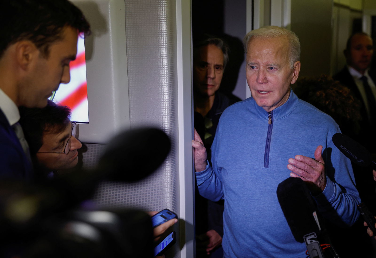 U.S. President Joe Biden gestures as he speaks to the press in front of the U.S. Secretary of State Antony Blinken, onboard of Air Force One en route from Israel, amid the ongoing conflict between Israel and Hamas, at Ramstein Air Base, Germany, October 18, 2023. 