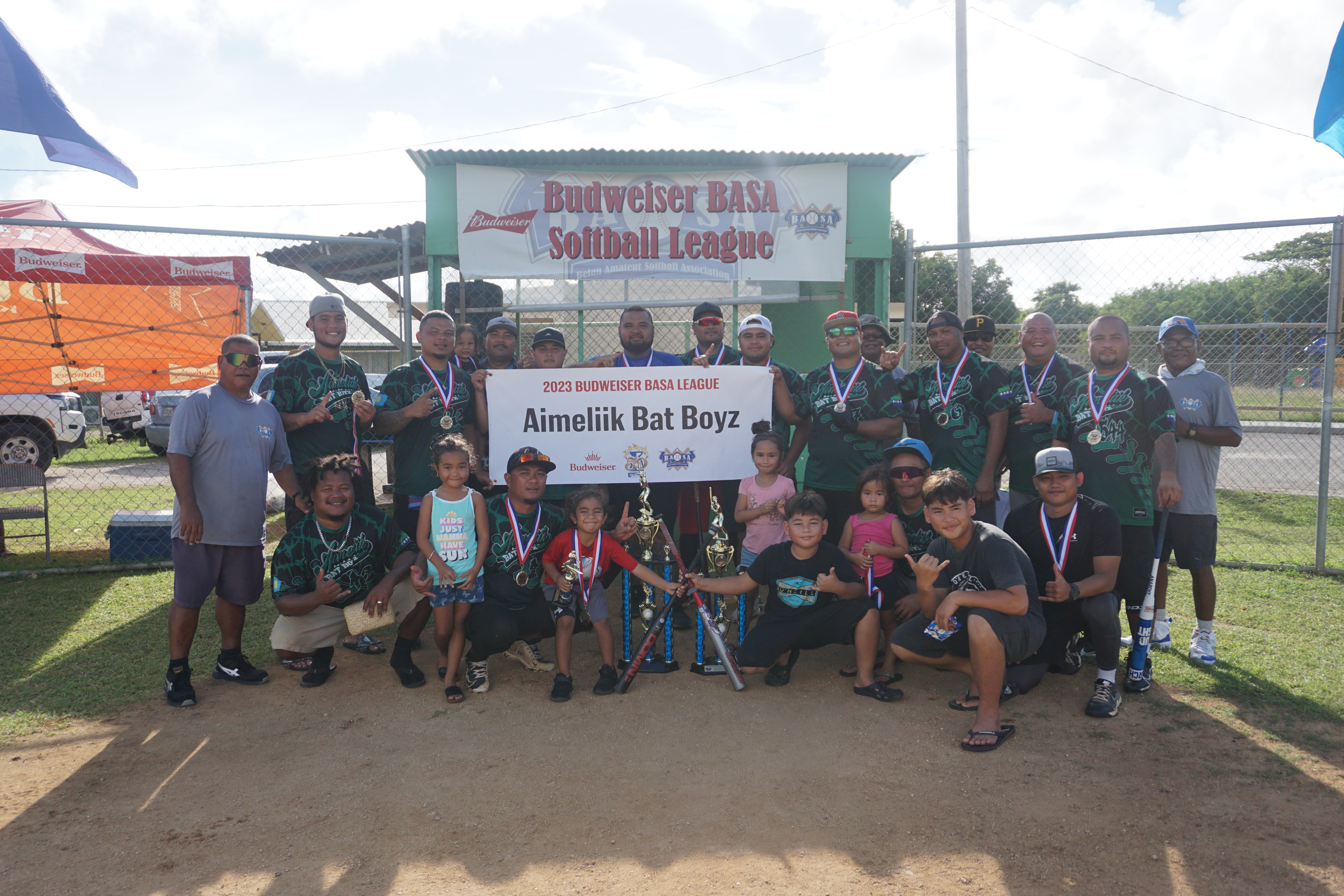 Aimeliik Bat Boyz pose with the championship trophy of the 2023 Budweiser Belau Amateur Softball Association Open League at the Dandan baseball field on Sunday.