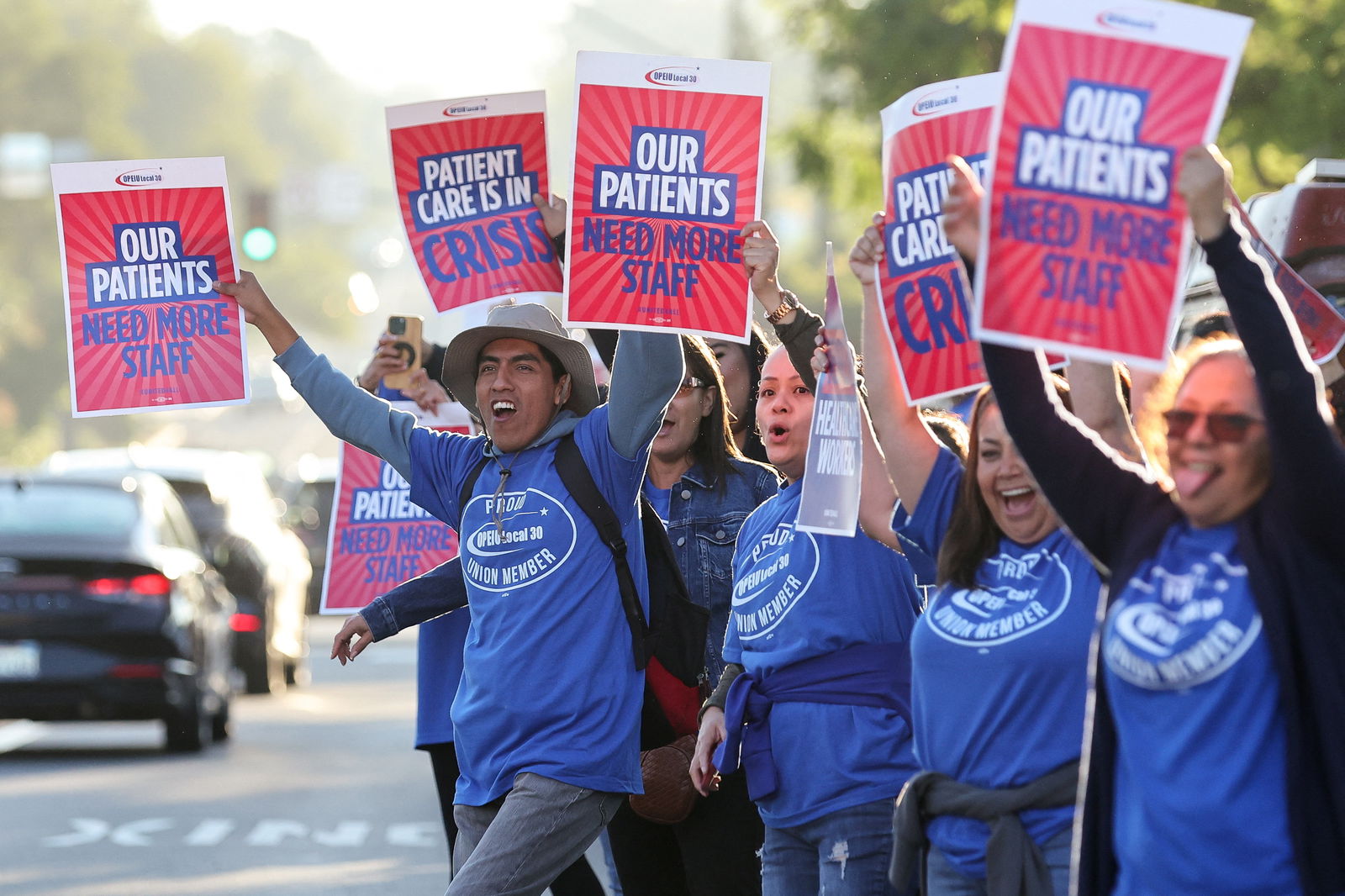 People hold placards, as a coalition of Kaiser Permanente Unions representing 75,000 healthcare workers at Kaiser Permanente start a three day strike across the United States over a new contract, in San Diego, California, U.S. October 4, 2023. 