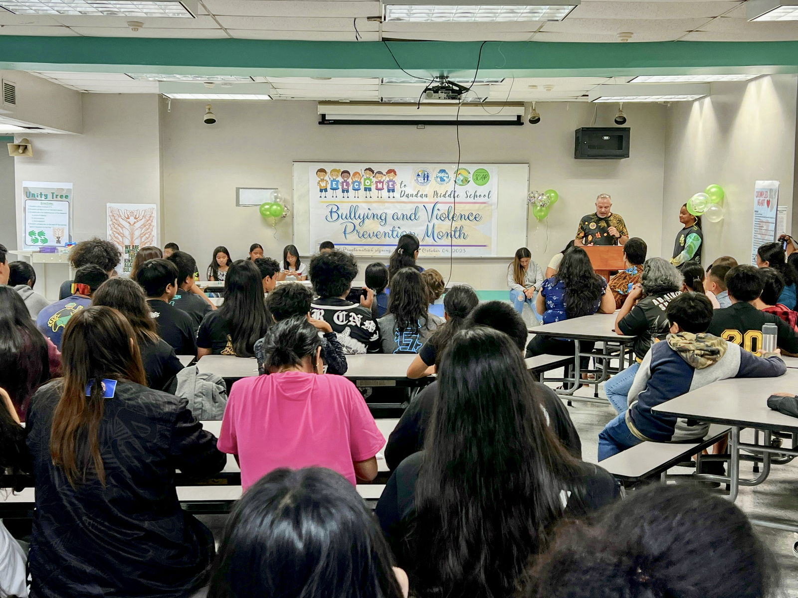 Board of Education Secretary-Treasurer Gregory Pat Borja speaks in the cafeteria of Dandan Middle School after signing a proclamation Wednesday designating October as Bullying and Violence Prevention Month.